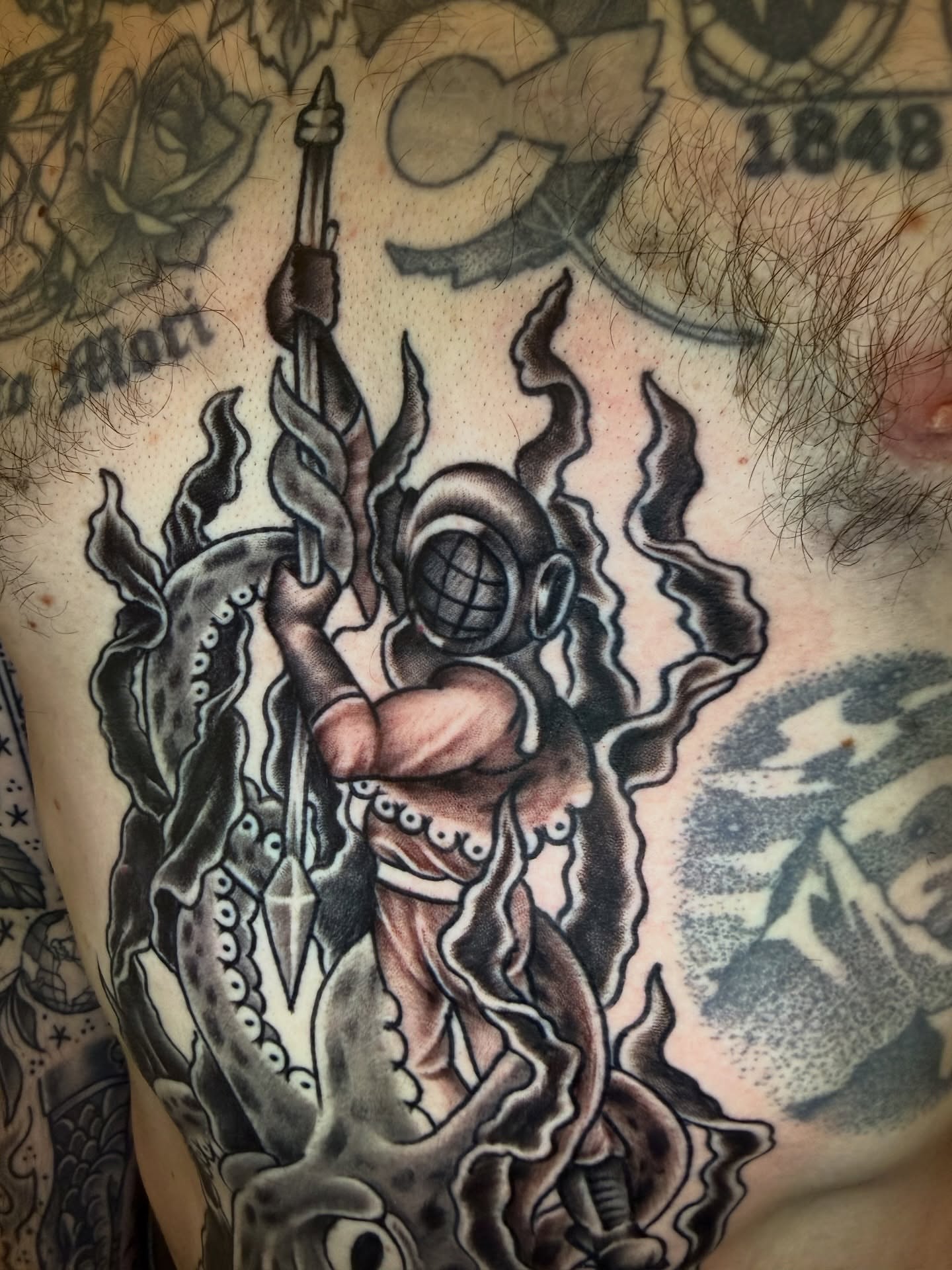 Diver and octopus American traditional tattoo on the chest by Kevin R. Onley