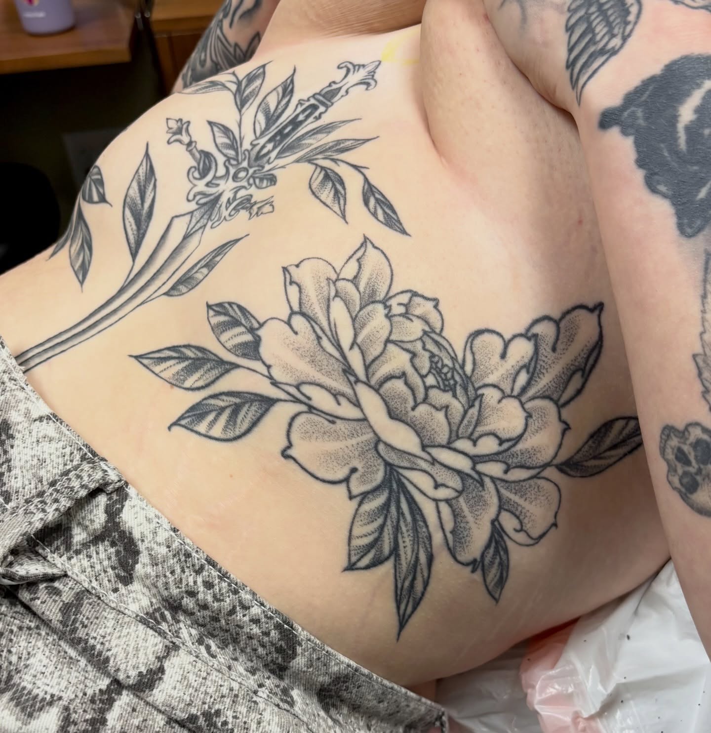 Peony black and grey tattoo on the ribs by sydney honn