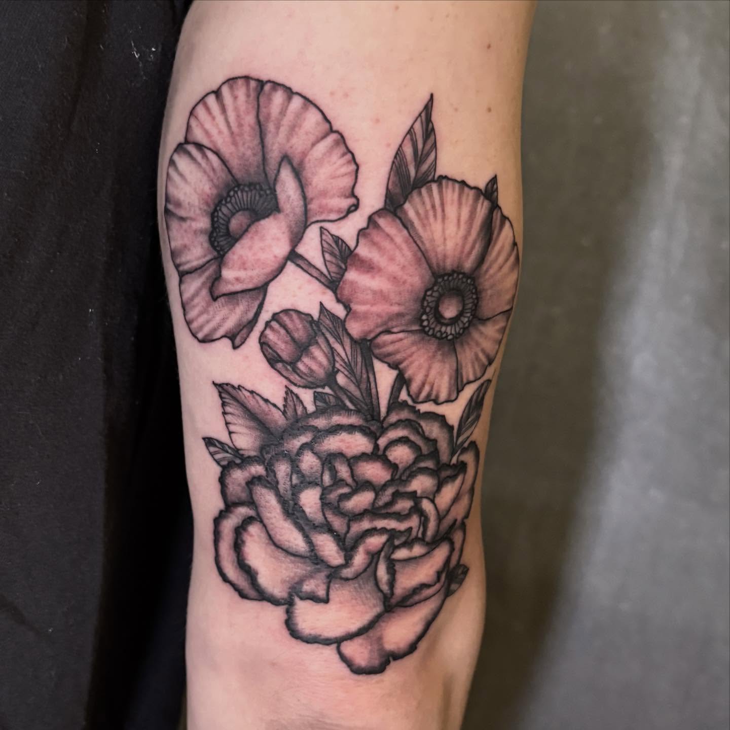 Flowers black and grey tattoo on the forearm by Dallas Davis