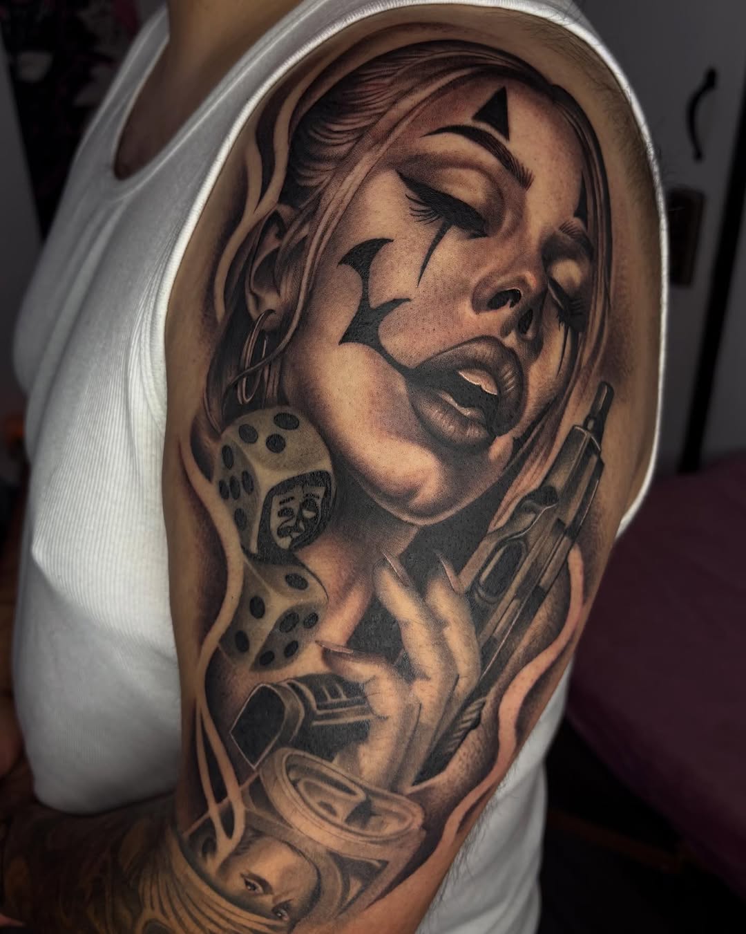 Clown woman with gun and dice Chicano tattoo on the shoulder by Savana ☆