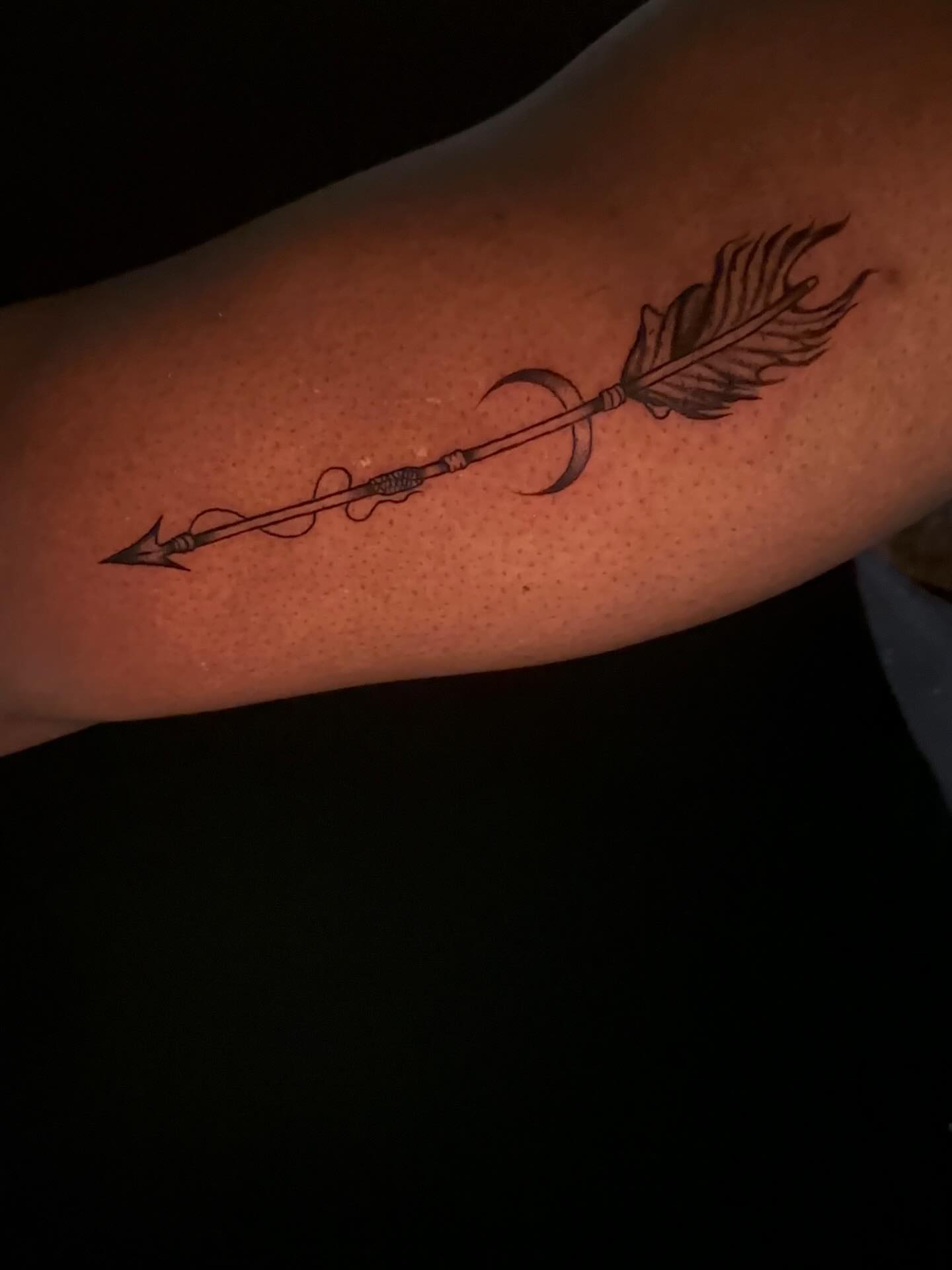 Arrow with feather black and grey tattoo on the forearm by Cherry Tats🍒