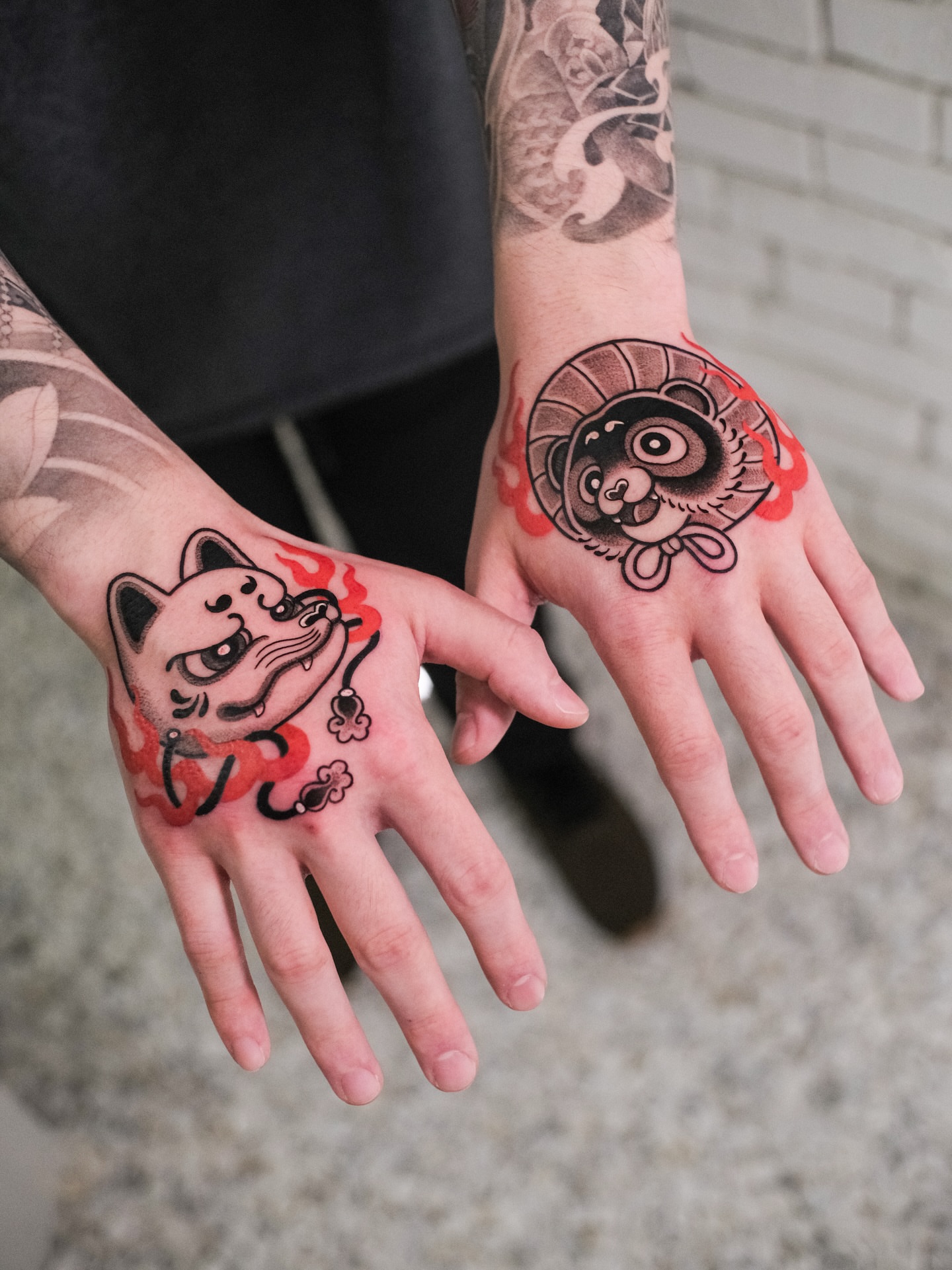 Cat and raccoon dotwork tattoo on the hand by seattle tattoo artist