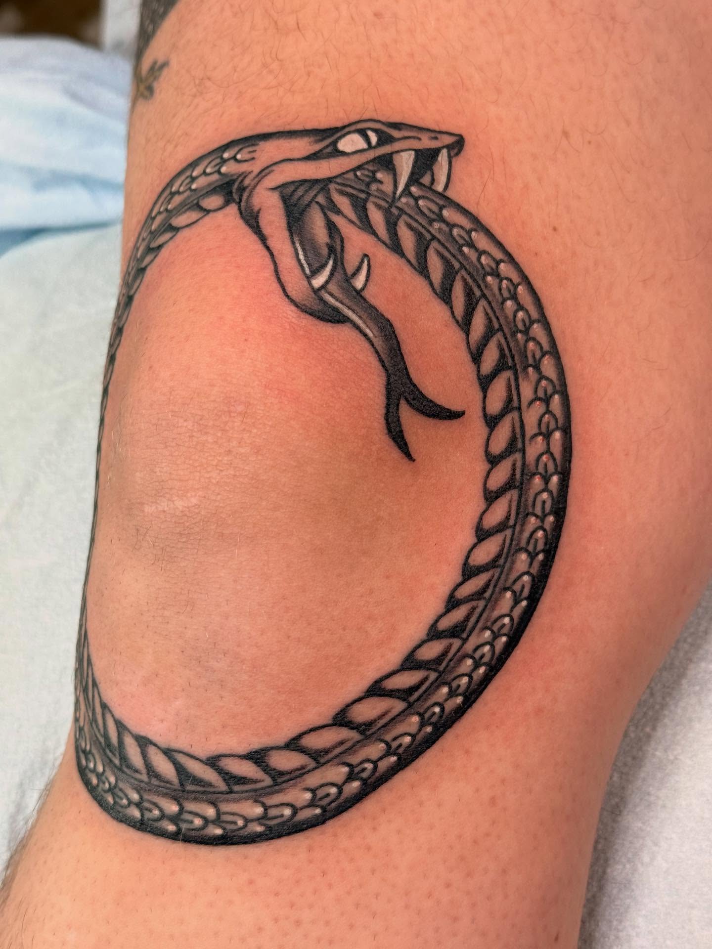 Snake black and grey tattoo on the thigh by Megan Sue Causemaker