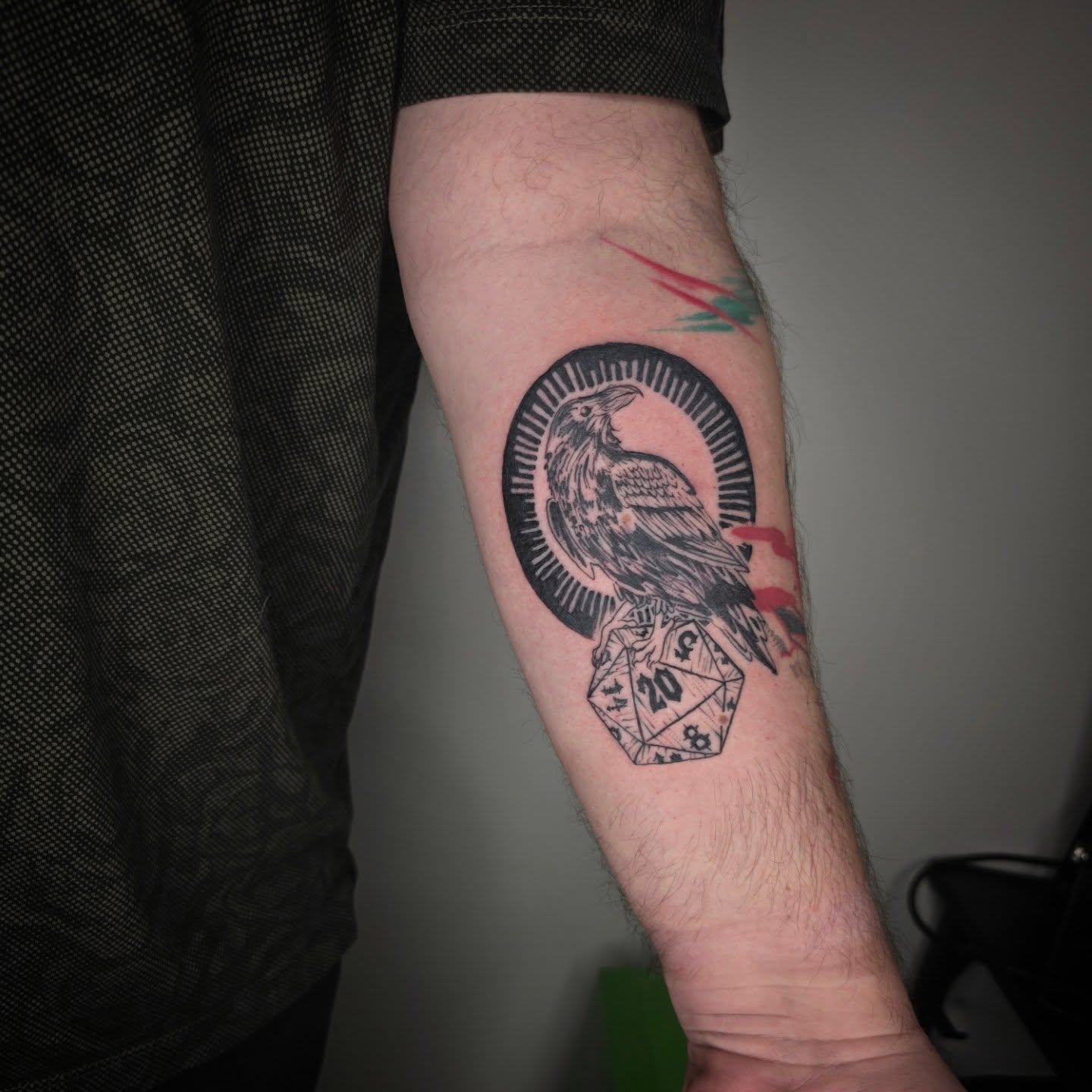 Raven and dice black and grey tattoo on the forearm by julian
