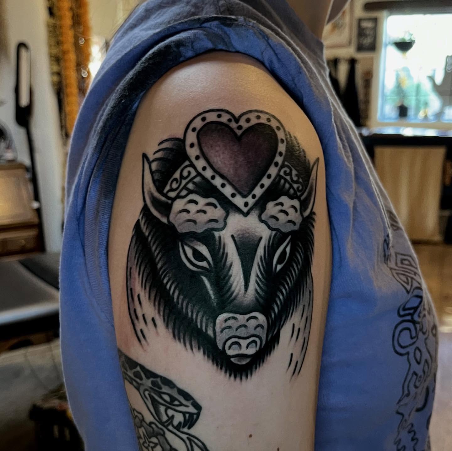 Bull with heart crown American traditional tattoo on the shoulder by Eli Bernal
