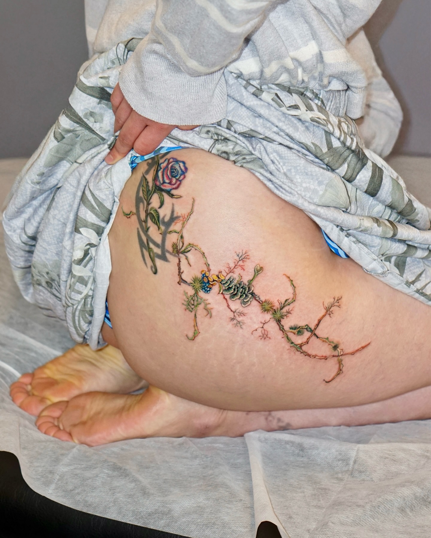 Botanical branch dotwork tattoo on the thigh by Isle