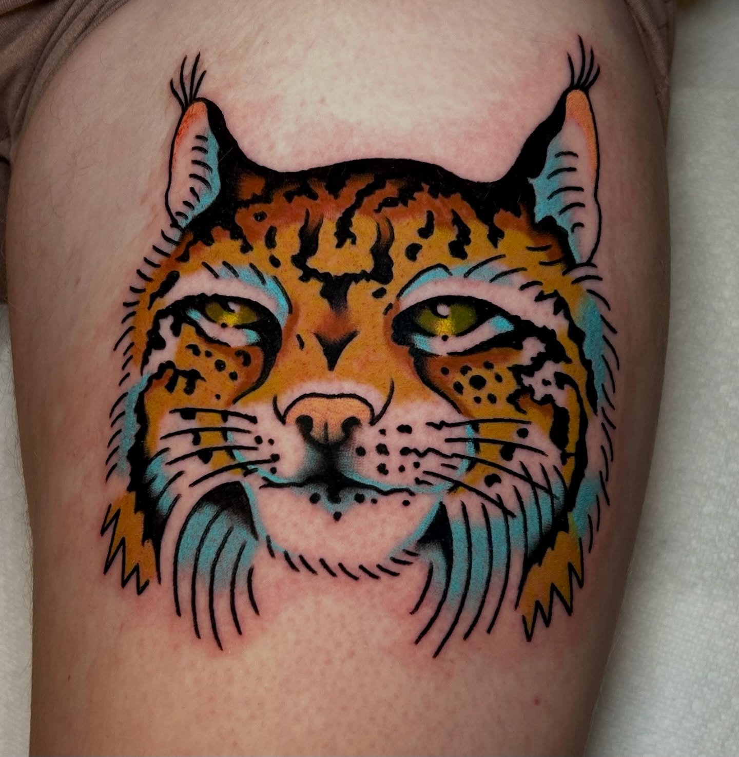 Lynx head American traditional tattoo on the thigh by Mitch Hoggard