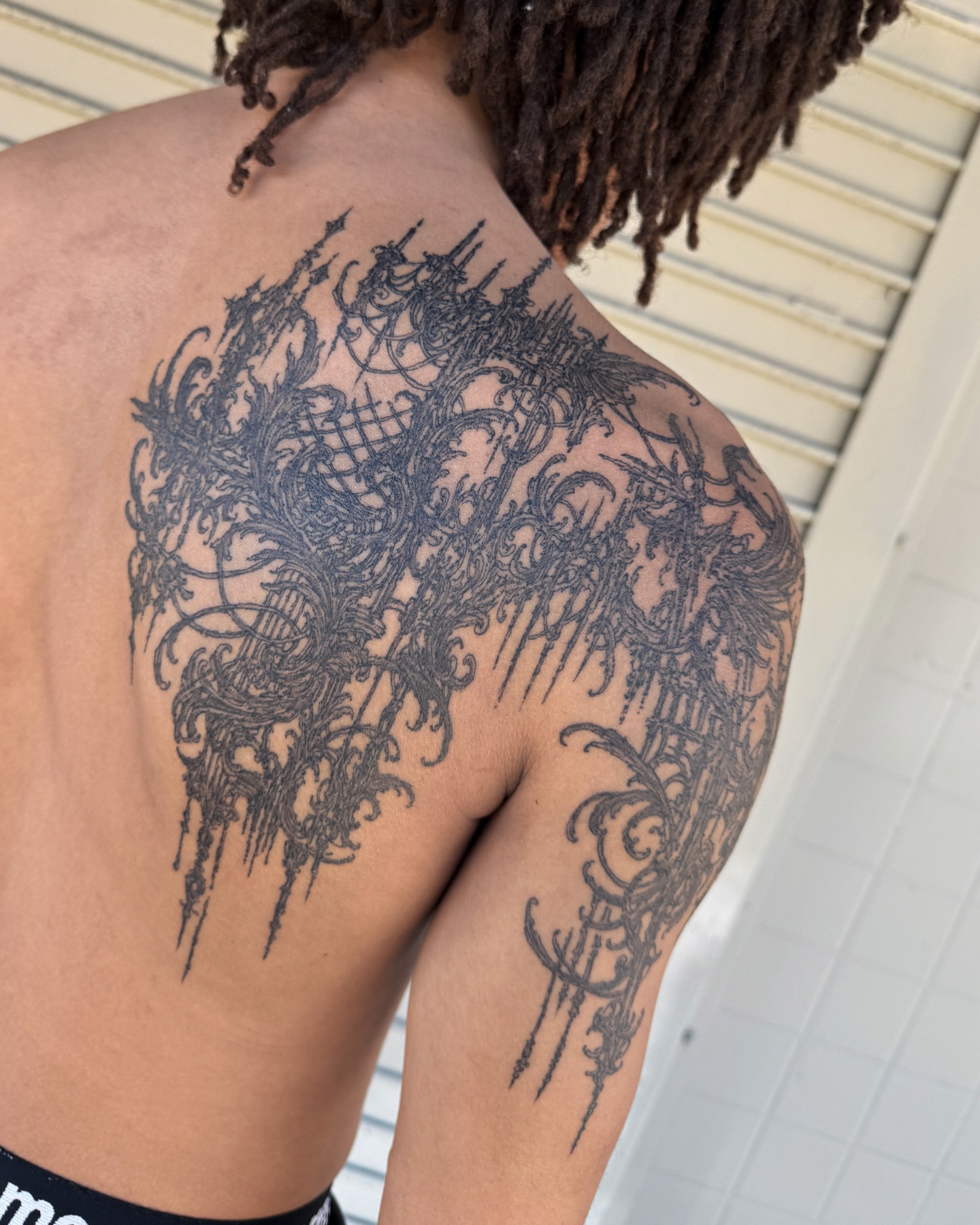 Abstract design ornamental tattoo on the back by Penelope