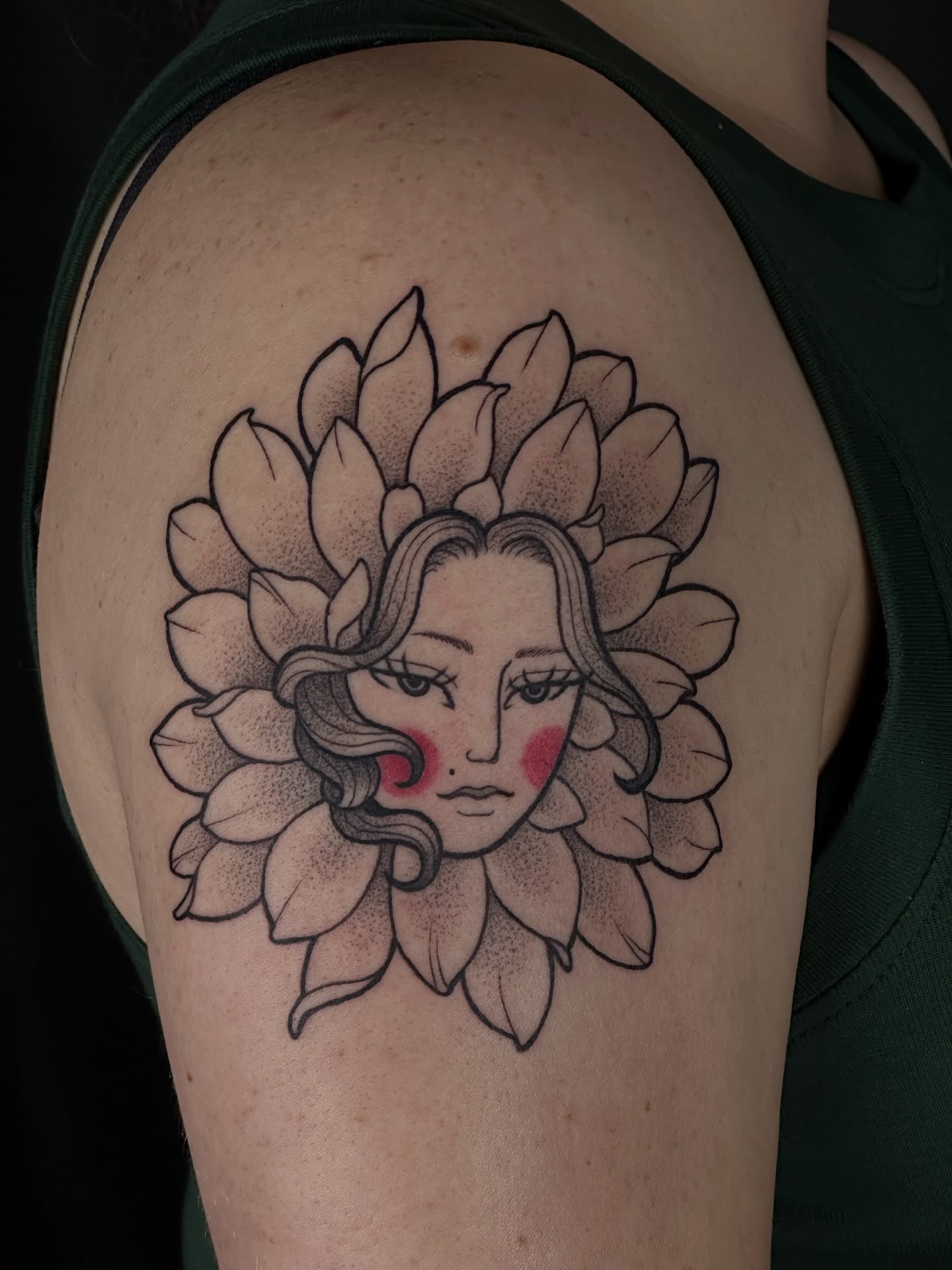 Flower with woman's face dotwork tattoo on the shoulder by Zoe Arrigo