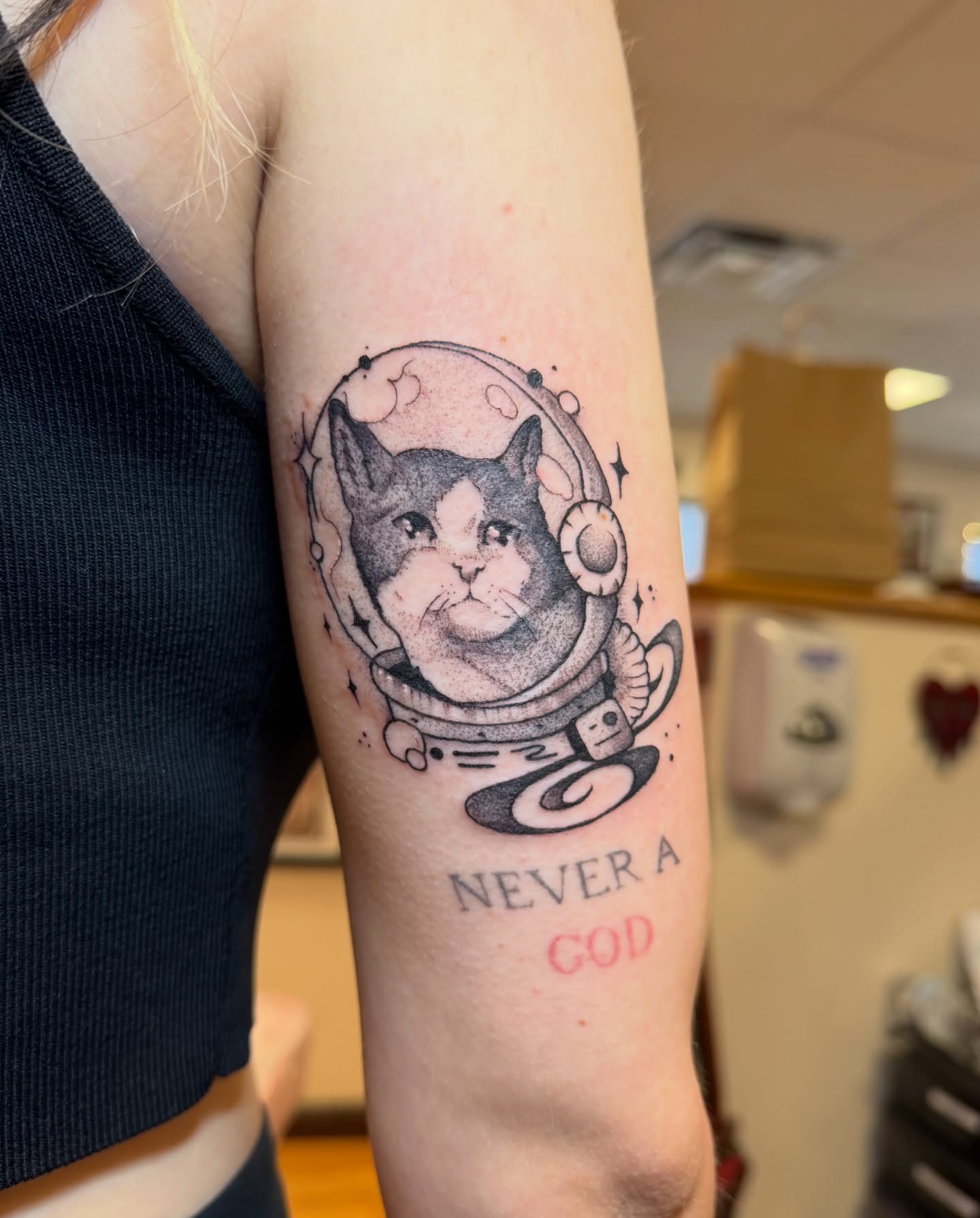Cat astronaut dotwork tattoo on the forearm by Gianna Calisi