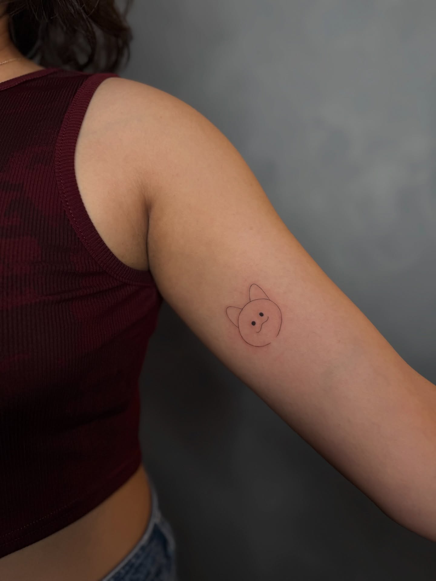 Cat minimalist tattoo on the forearm by Fineline Tattoos DFW