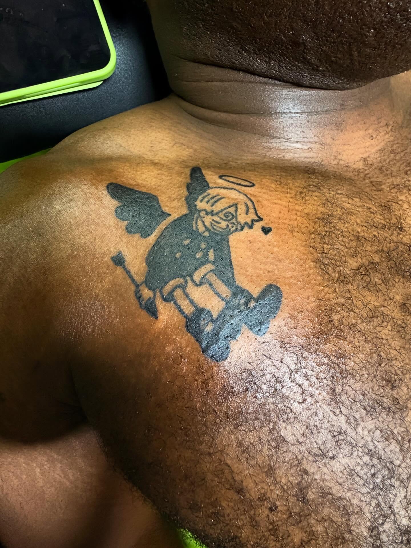 Angel with pitchfork black and grey tattoo on the chest by Ms Thick