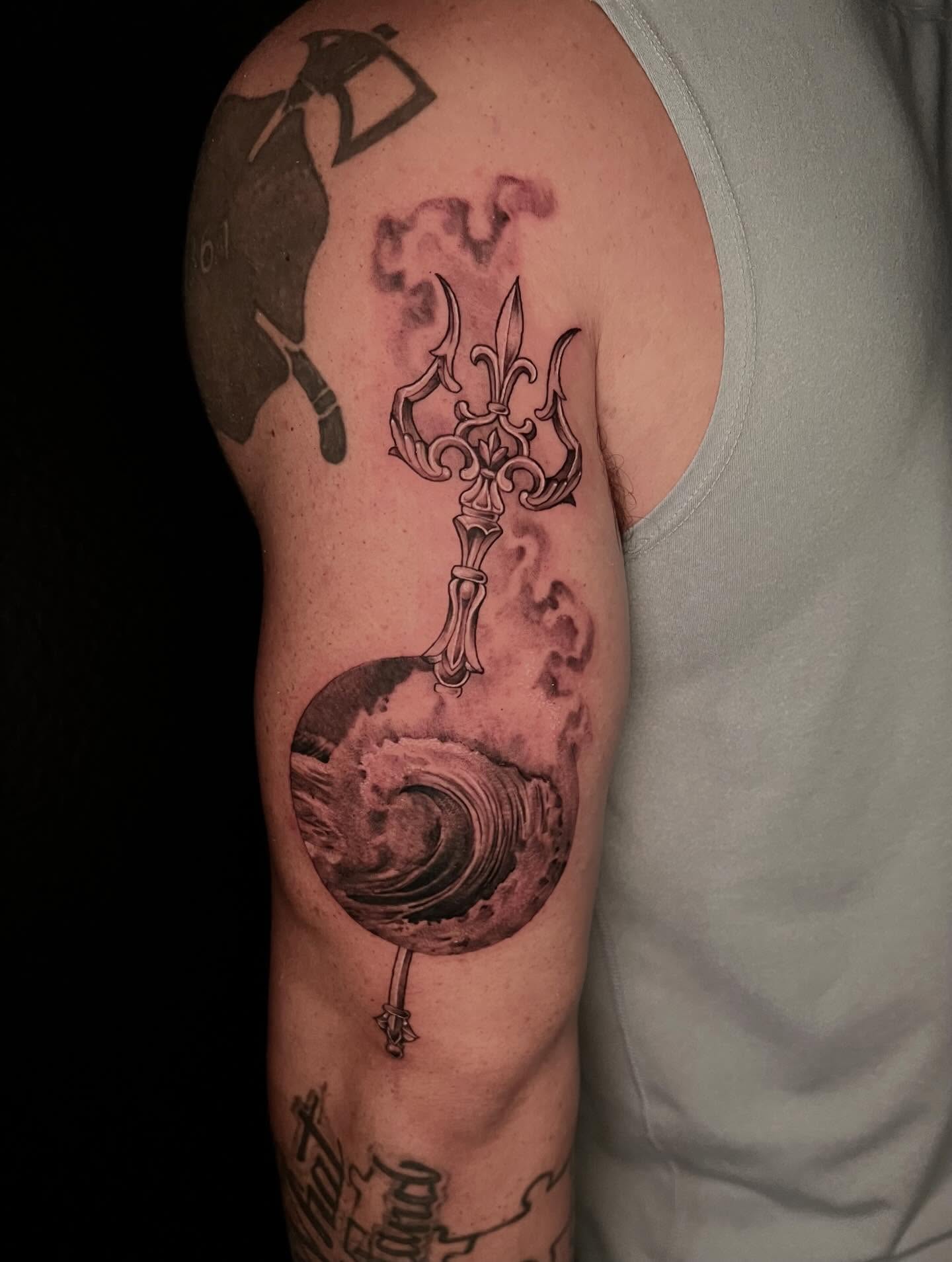 Trident and planet realism tattoo on the upper arm by Joi Bailey, Denton, Texas