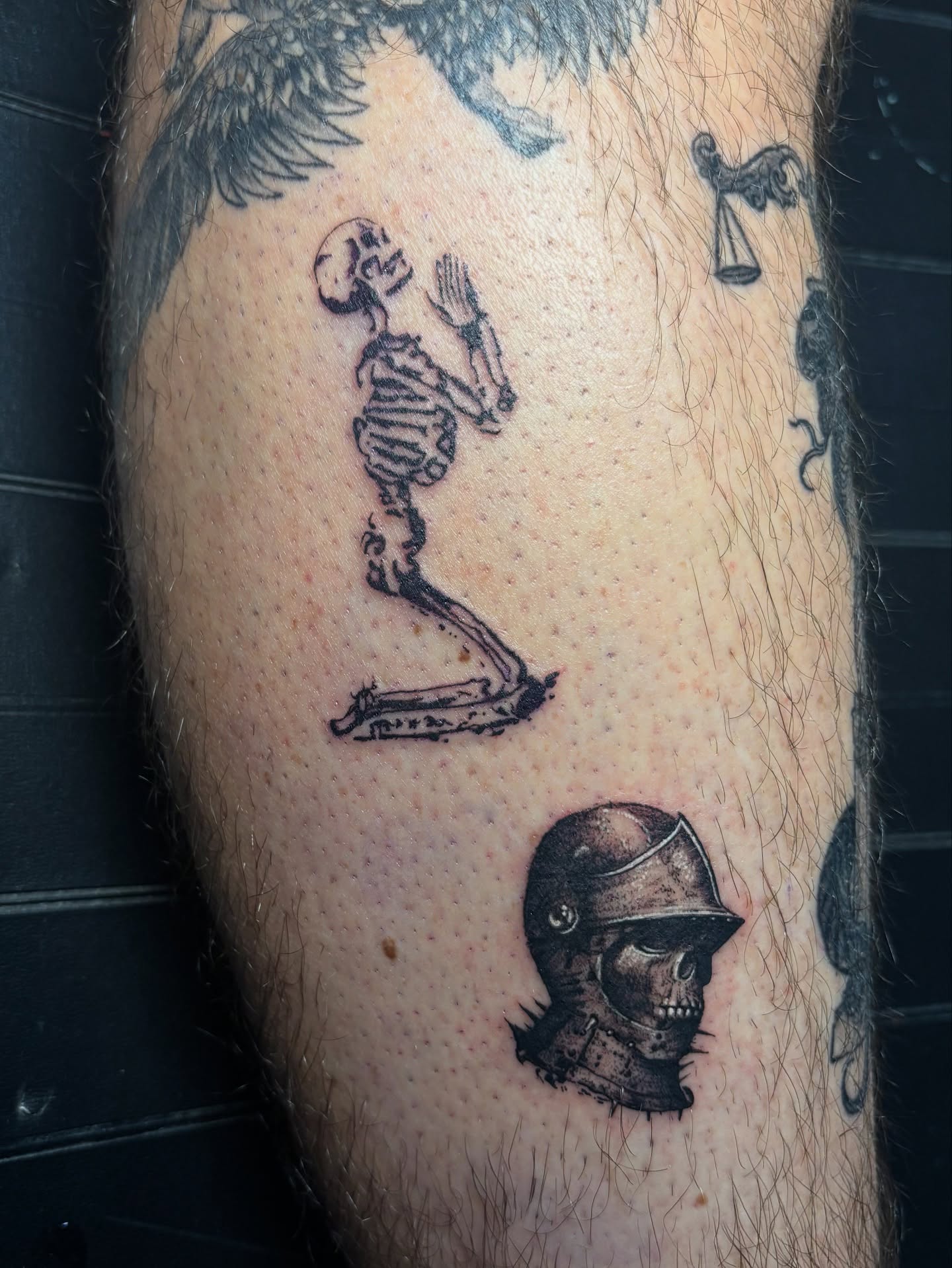 Skeleton and knight helmet black and grey tattoo on the forearm by Terik Whittaker
