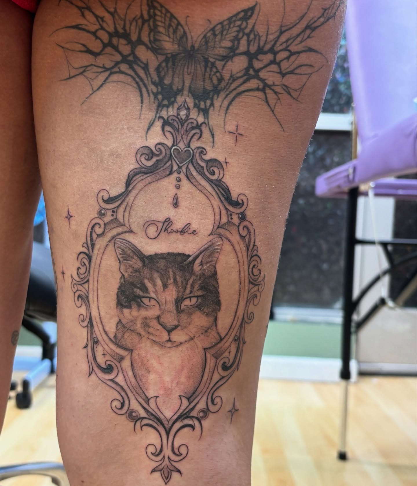 Cat portrait realism tattoo on the thigh by Ivanna
