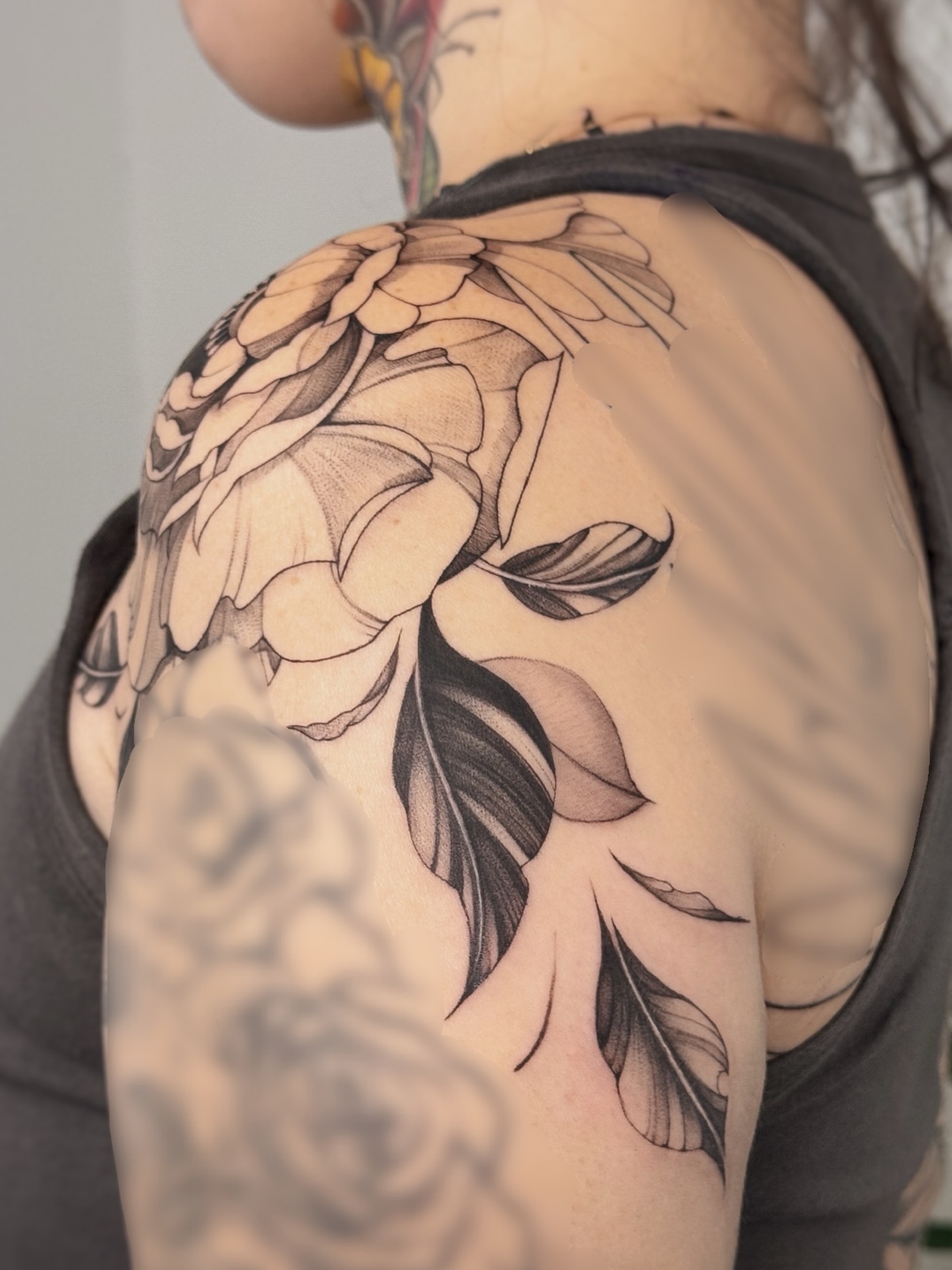 Floral black and grey tattoo on the shoulder by Gianna Rodriguez
