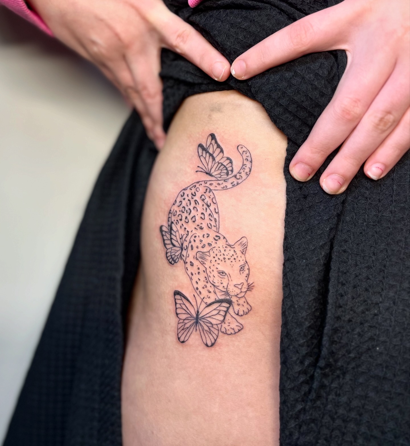 Leopard and butterflies black and grey tattoo on the thigh by brinley - fine line tattoos, Crescent Springs, Kentucky