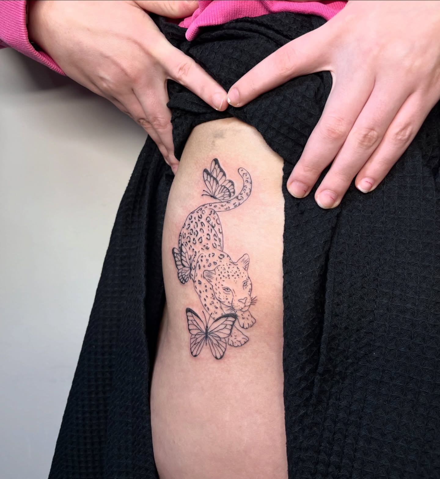 Leopard and butterflies black and grey tattoo on the thigh by brinley - fine line tattoos, Crescent Springs, Kentucky