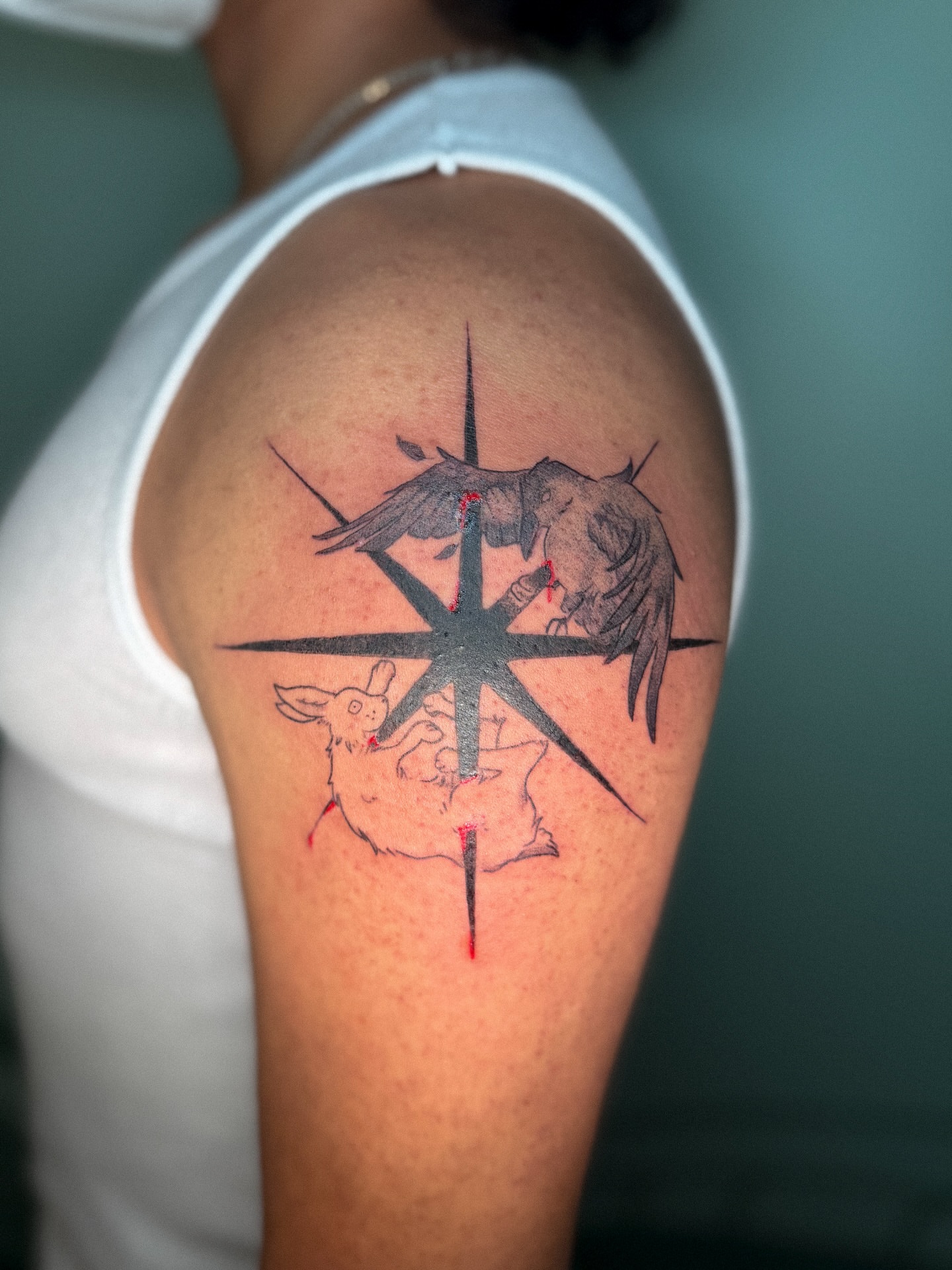 Compass with bird and rabbit geometric tattoo on the shoulder by madison
