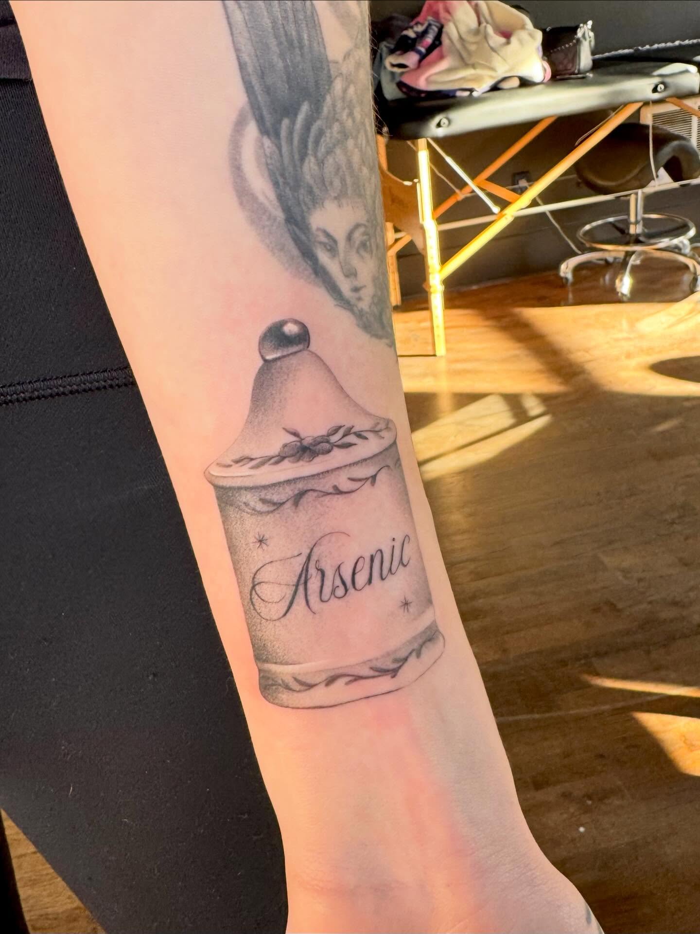 Arsenic bottle black and grey tattoo on the forearm by Lily Cuoio~ Seattle