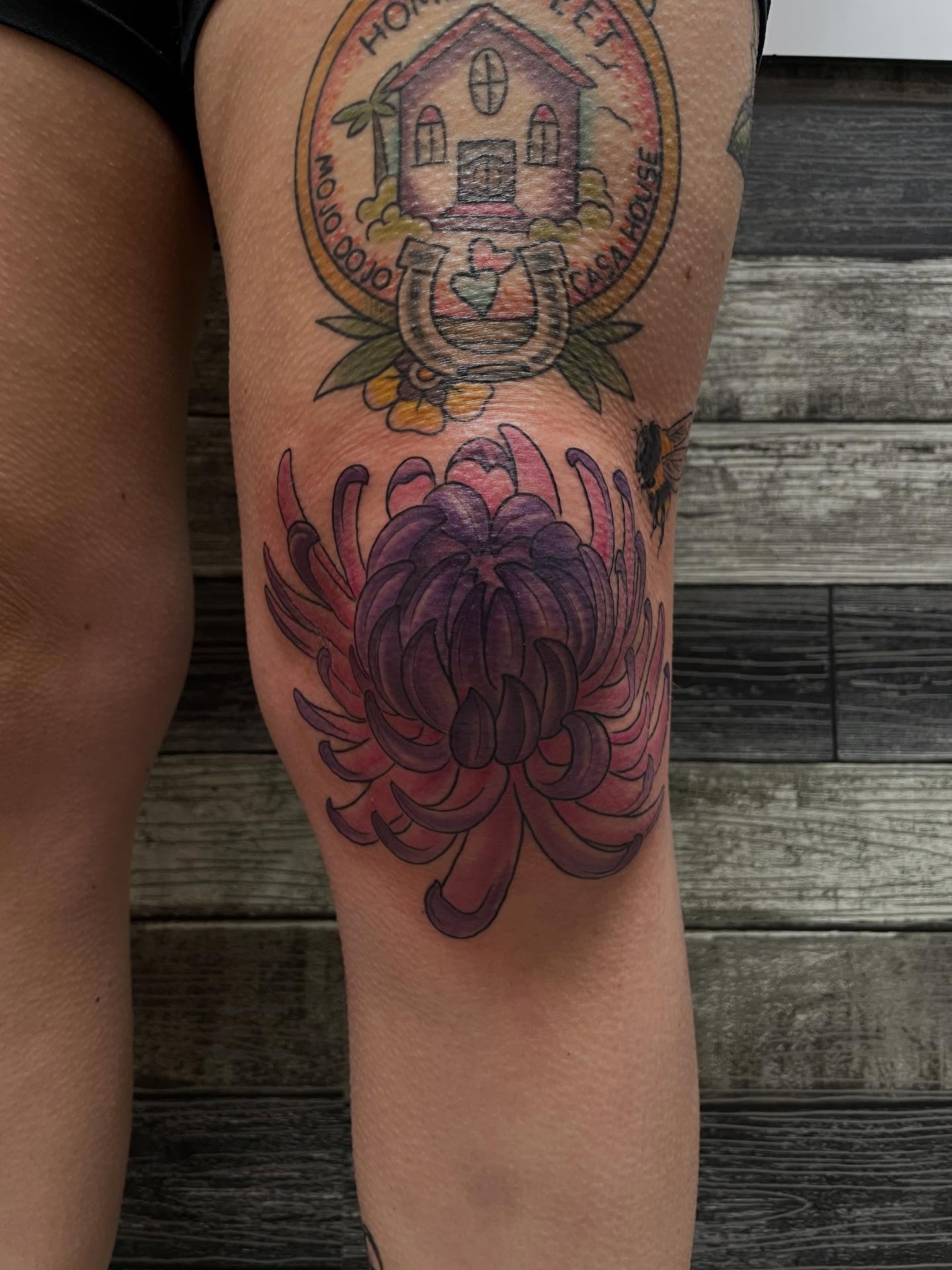 Chrysanthemum American traditional tattoo on the thigh by Stevie Timmreck, Utica, Michigan