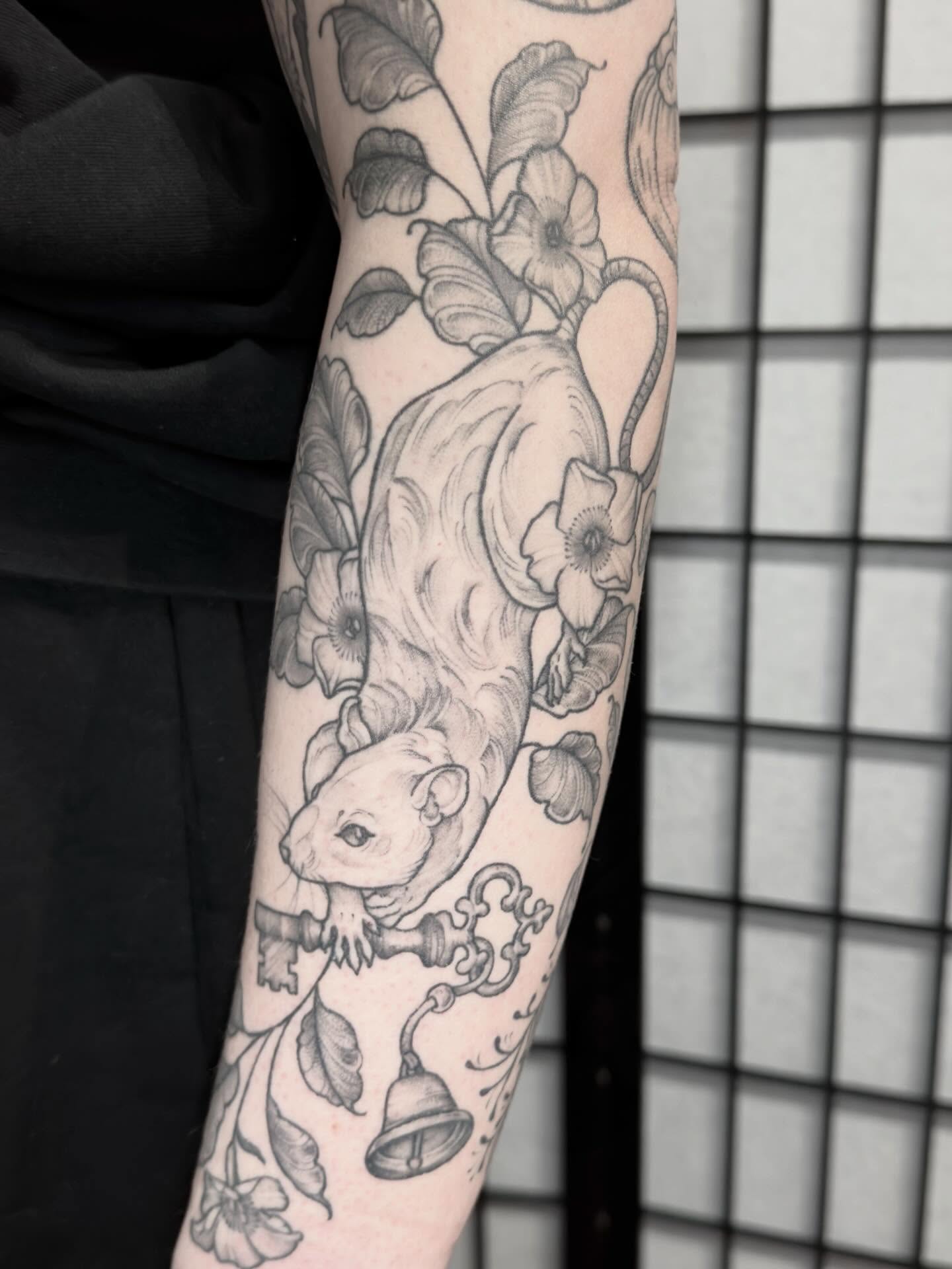 Rat and floral black and grey tattoo on the forearm by Kirsten Marsden Ballantyne