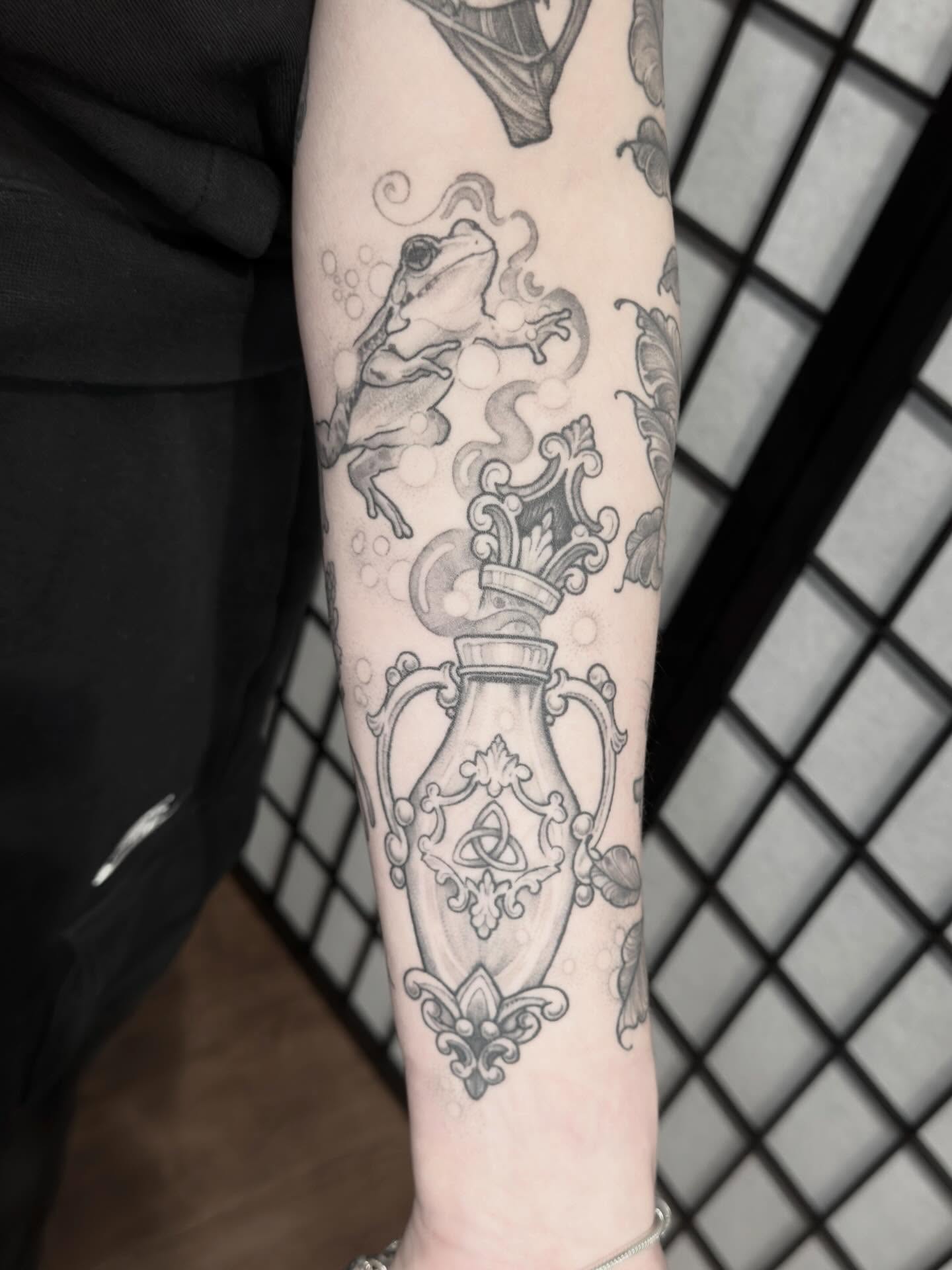 Frog and vase ornamental tattoo on the forearm by Kirsten Marsden Ballantyne