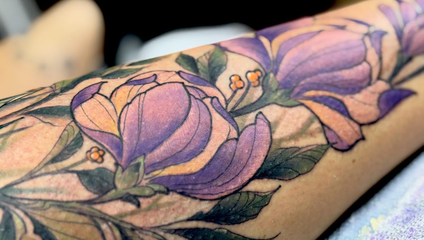Purple magnolia new school tattoo on the forearm by jonhighland