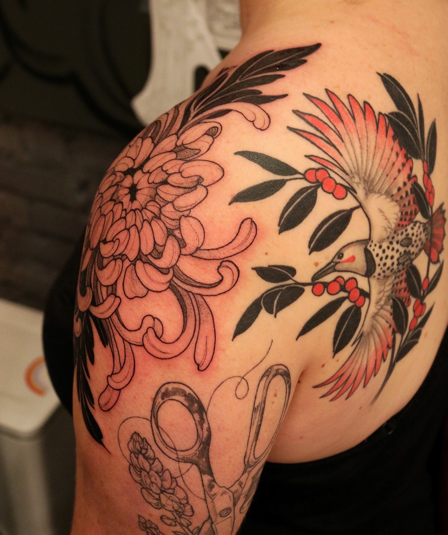 Bird and floral American traditional tattoo on the shoulder by Summer Balcom M.