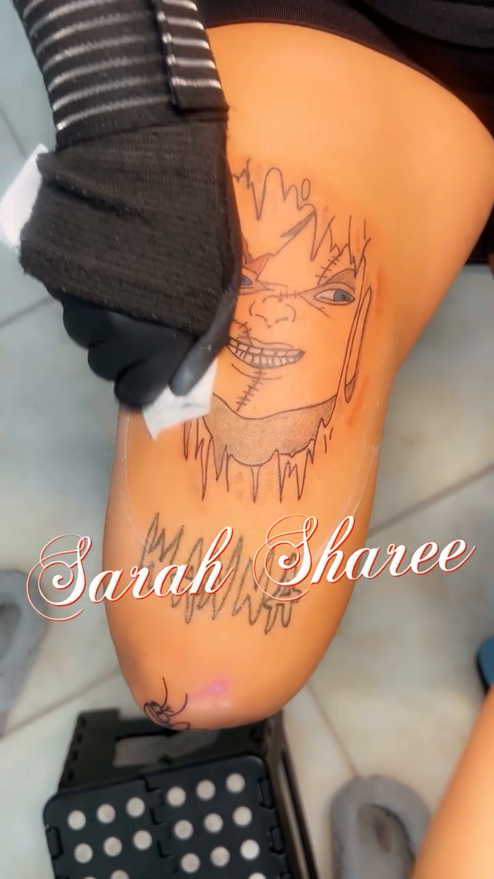 Character face with dripping effect realism tattoo on the thigh by Sarah Sharee💃🏽