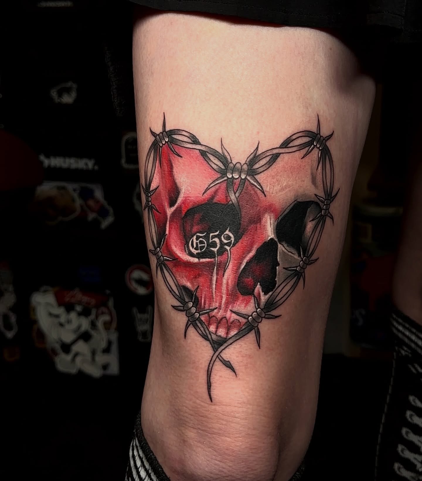 Barbed wire skull dark realism tattoo on the forearm by Denis Seregin
