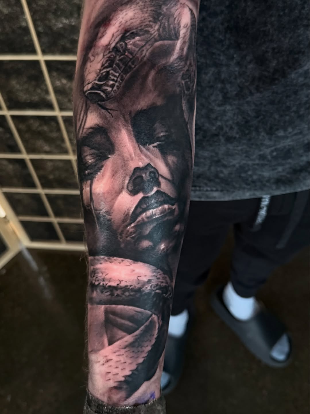 Woman and snake realism tattoo on the forearm by Miles Haysmith