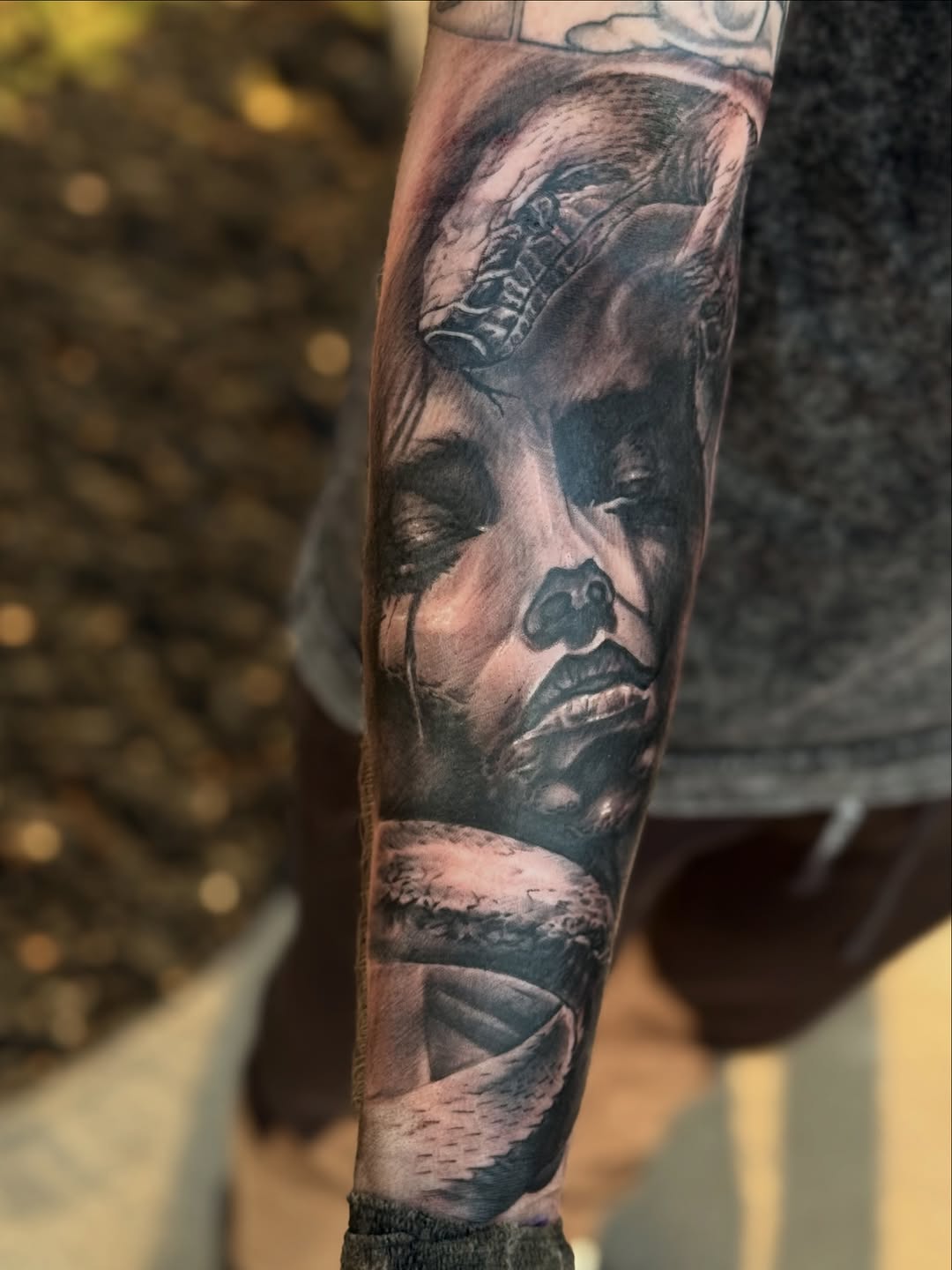 Woman and snake realism tattoo on the forearm by Miles Haysmith