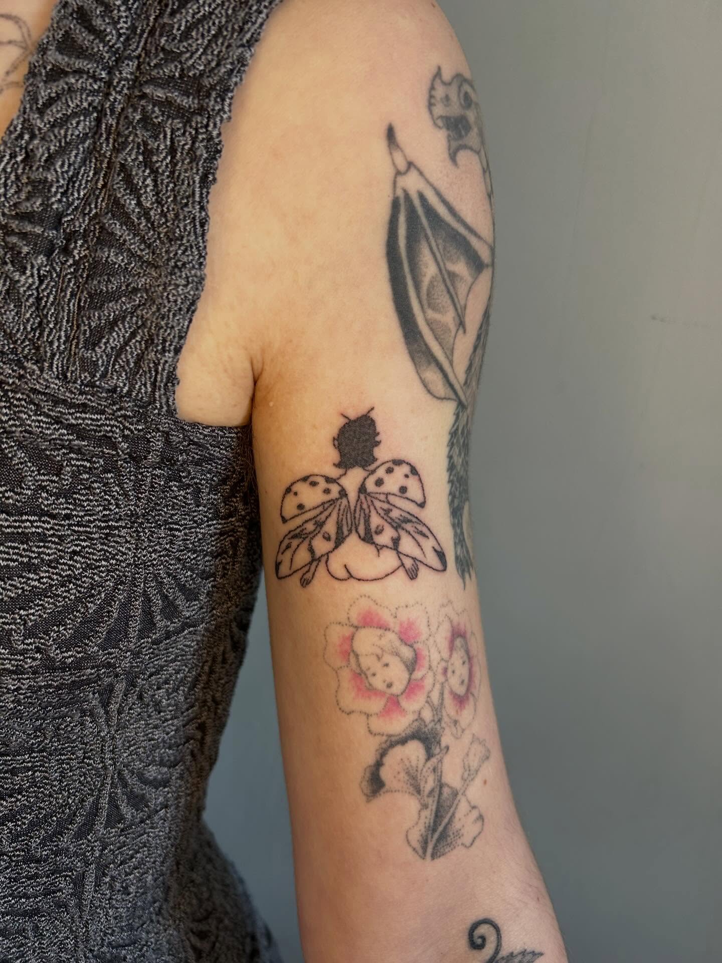 Butterfly and flowers black and grey tattoo on the forearm by ˙⋆✮⋆˙‧₊˚✧ sophie ✧˚₊‧˙⋆✮⋆˙