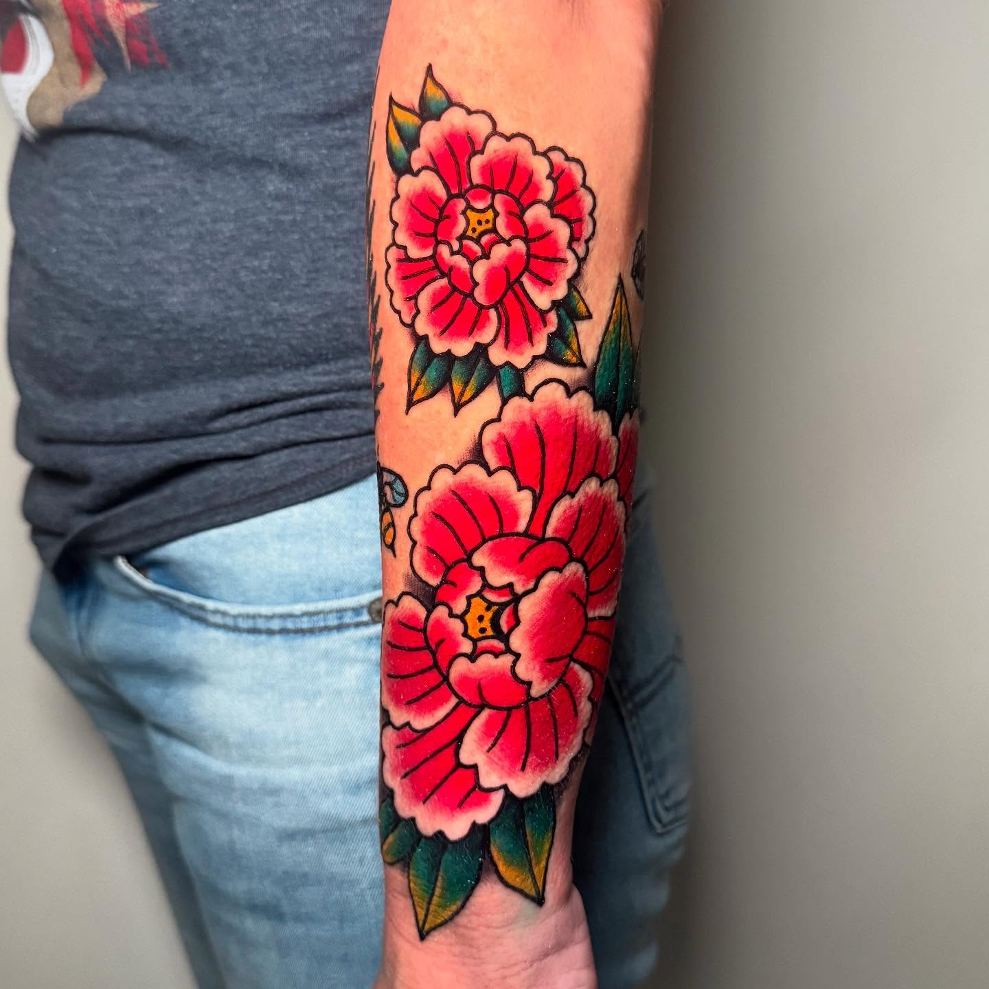 Peony flowers American traditional tattoo on the forearm by Zac Chaffin