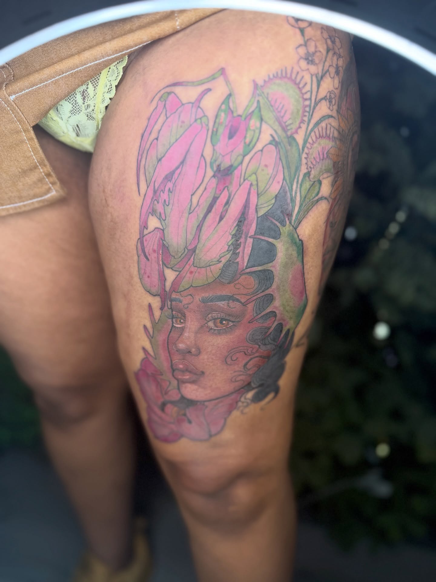 Woman with flowers dotwork tattoo on the thigh by Los Angeles Tattoo Artist