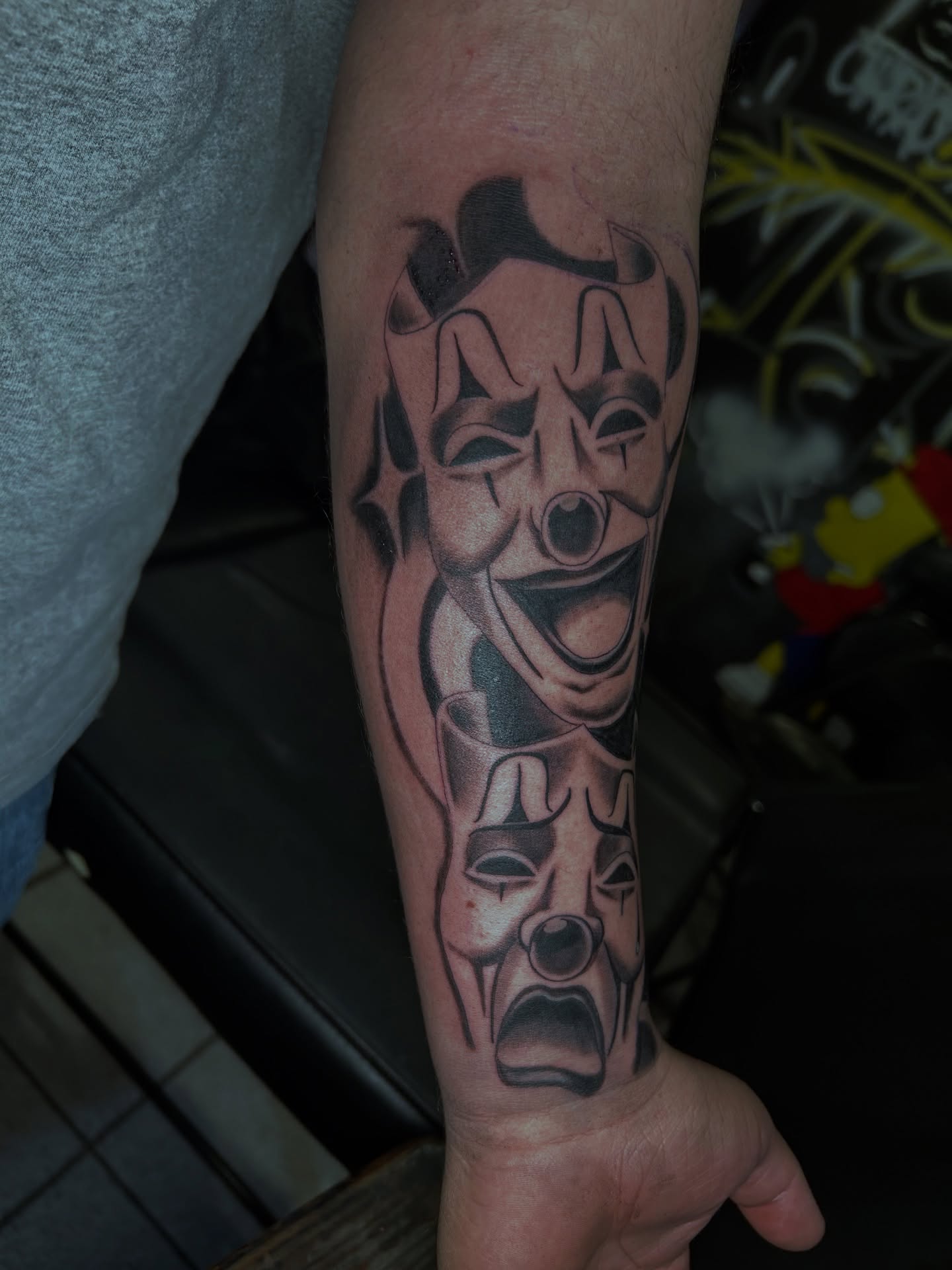 Theater masks black and grey tattoo on the forearm by Tito Cross ❤️‍🔥