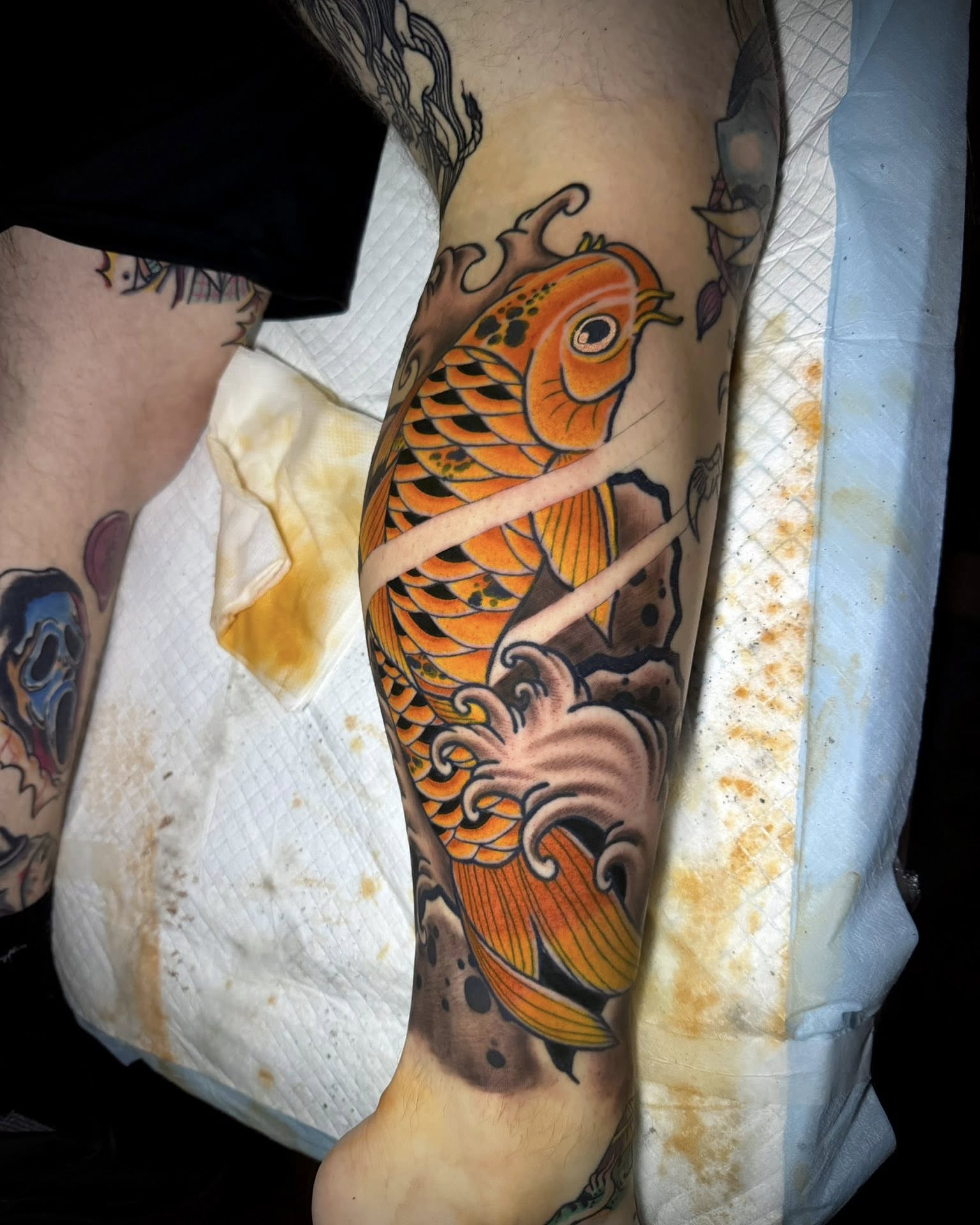 Koi fish American traditional tattoo on the forearm by Corey Bailey, Stanton, Kentucky
