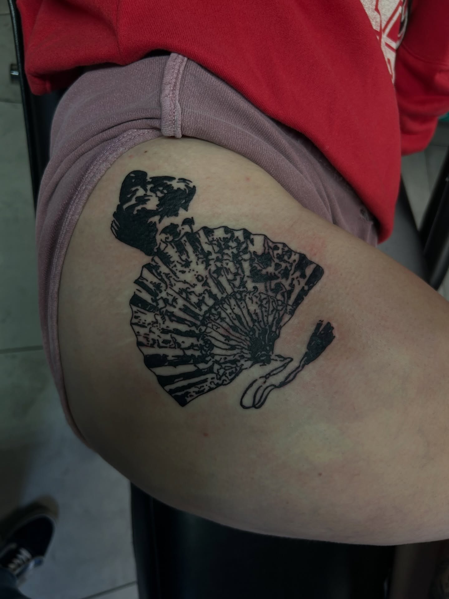 Fan and woman black and grey tattoo on the thigh by Torrey, Austin, Texas