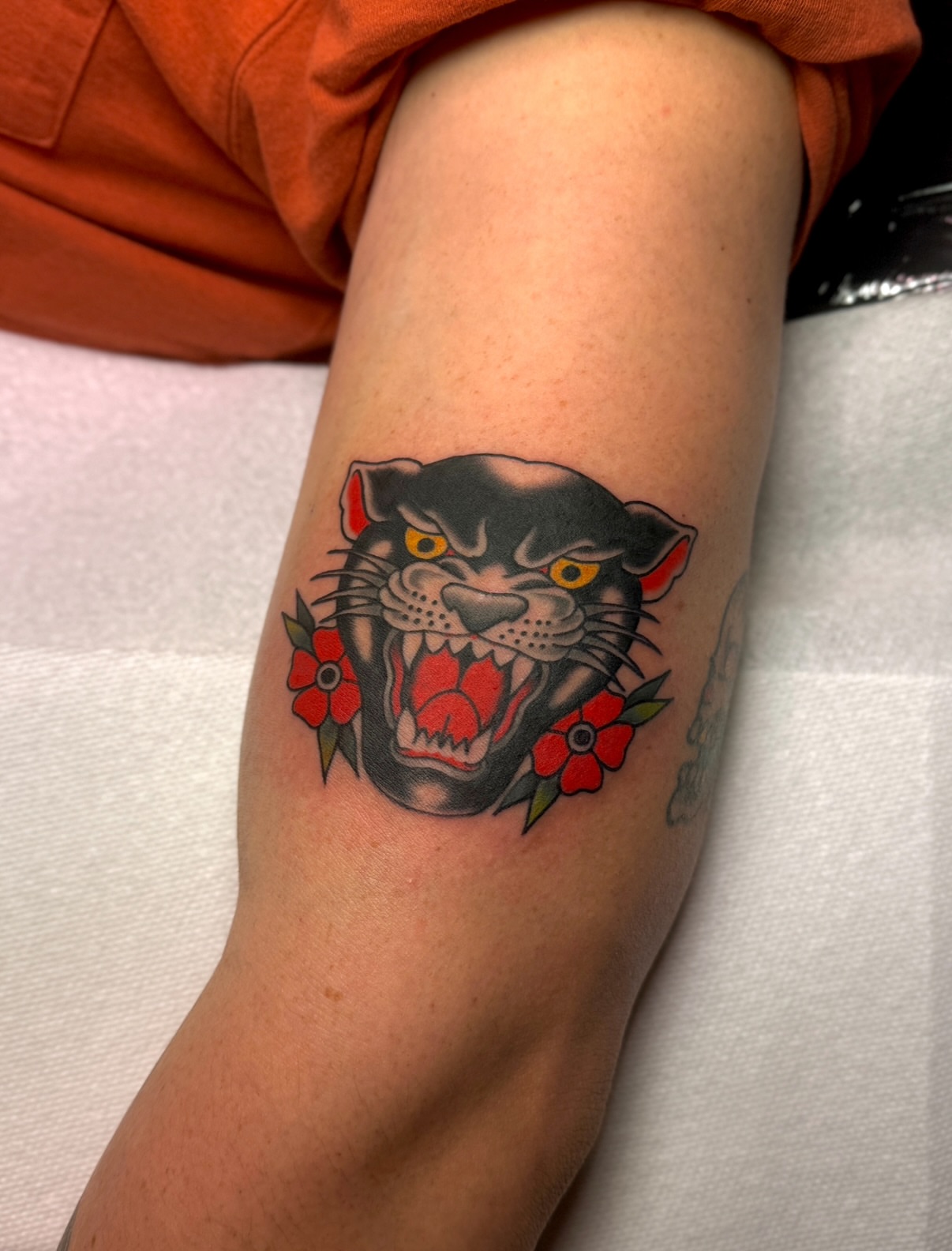 Panther with flowers American traditional tattoo on the forearm by Ethan, Toledo, Ohio