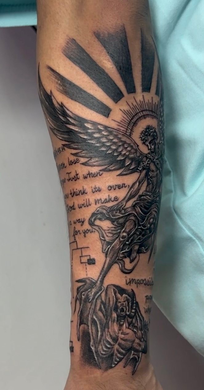 Angel and demon with text realism tattoo on the forearm by Gerd thINK_TATTOO