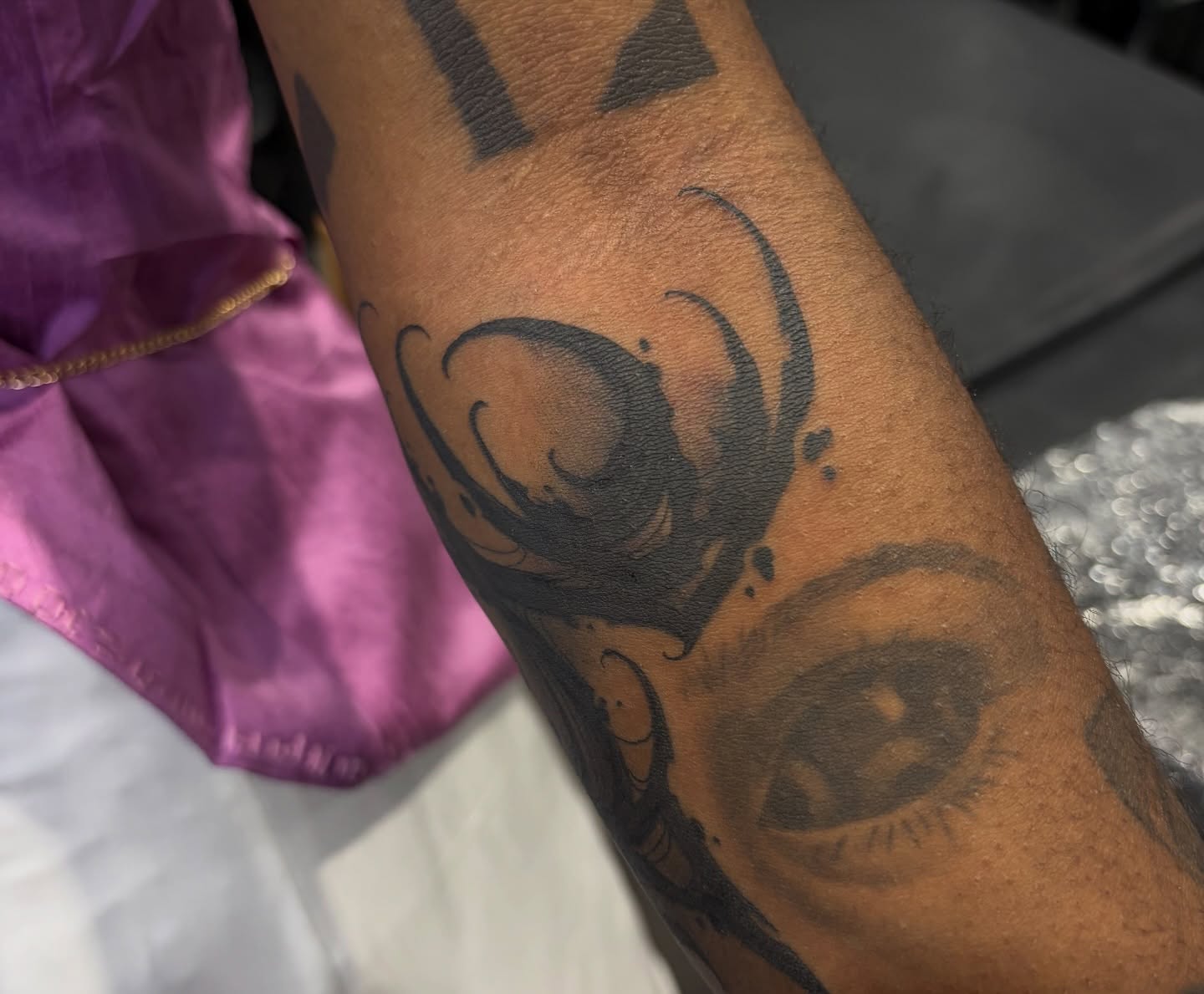 Eye black and grey tattoo on the forearm by BodyArtByAlia