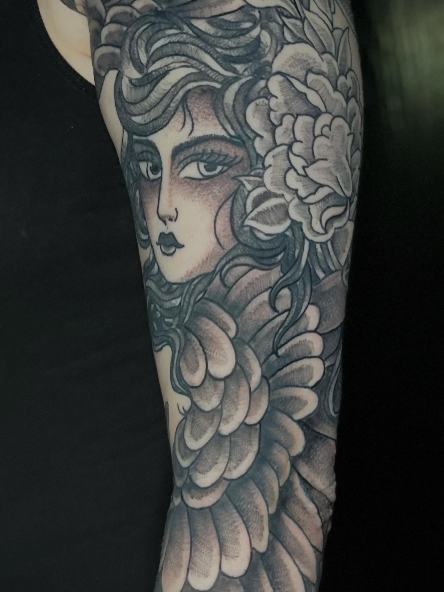 Woman with flowers realism tattoo on the forearm by CRAIG B⛓️ Cincinnati Tattoo Artist