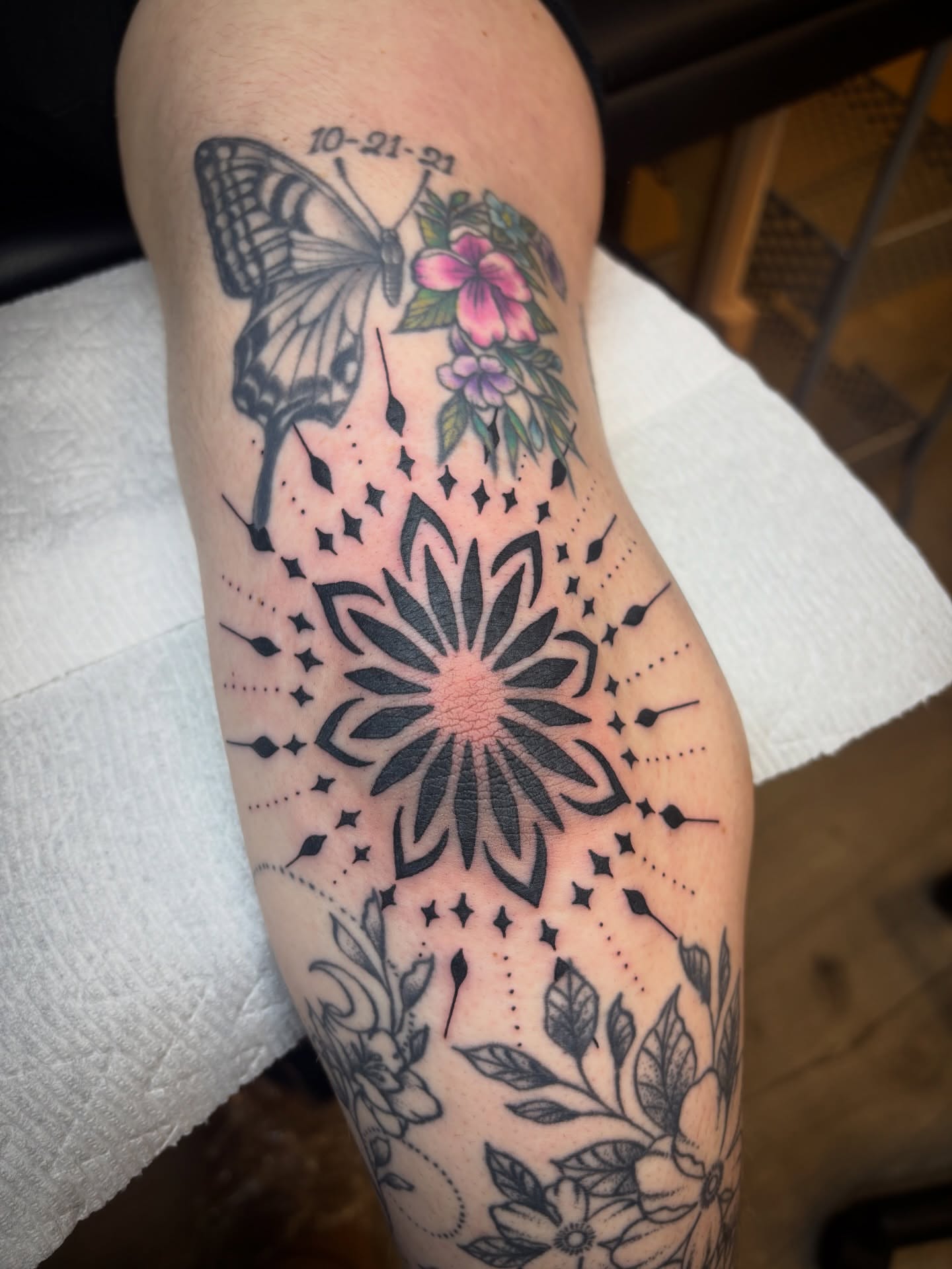 Butterfly and floral mandala American traditional tattoo on the forearm by Malia Clark
