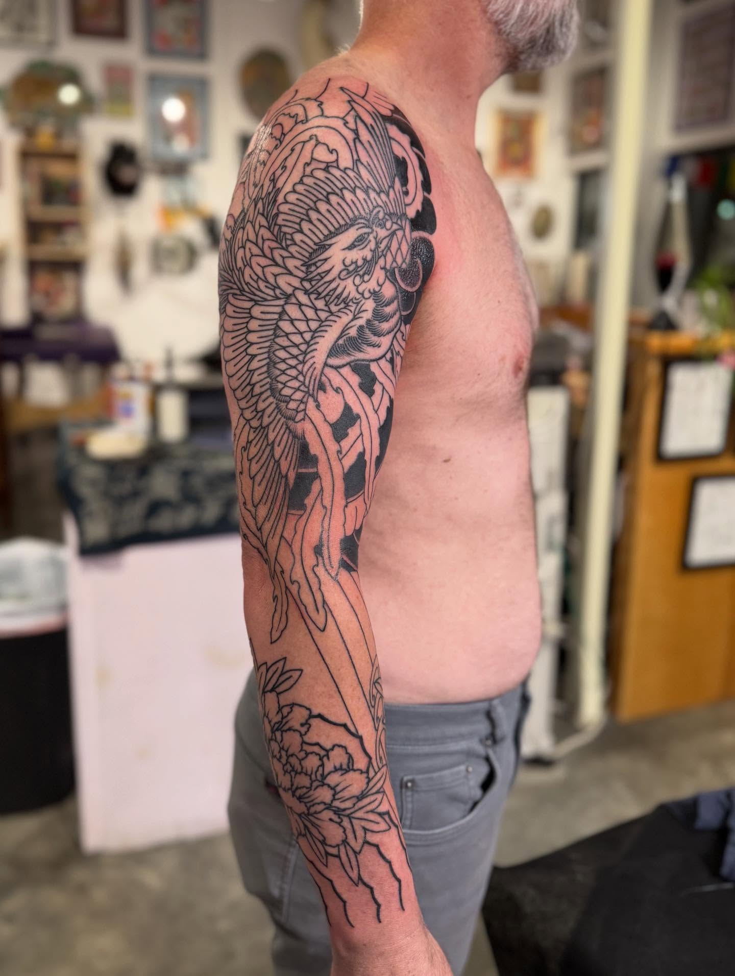 Peacock and floral japanese irezumi tattoo on the upper arm by Jason Eisenberg