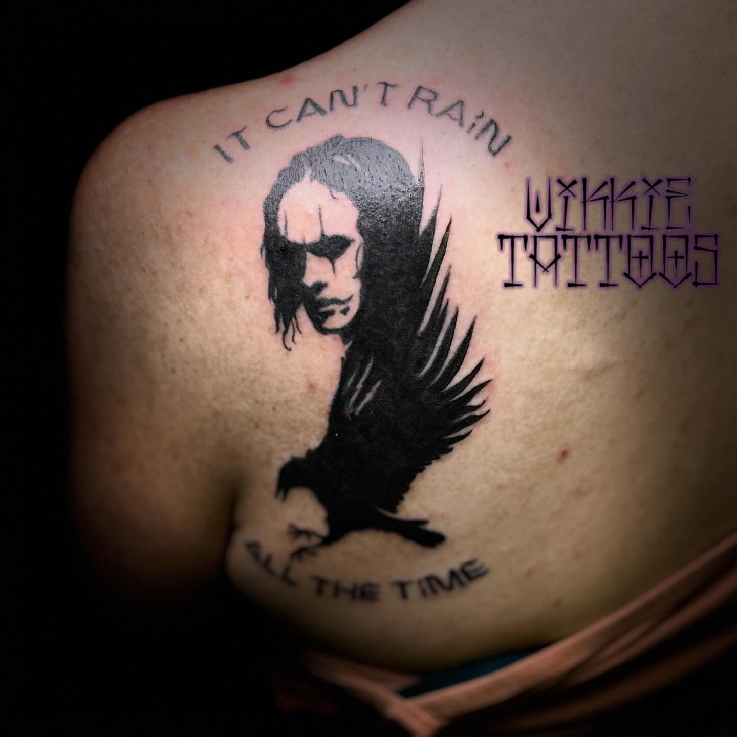 Crow and face black and grey tattoo on the shoulder by Victoria Mendez