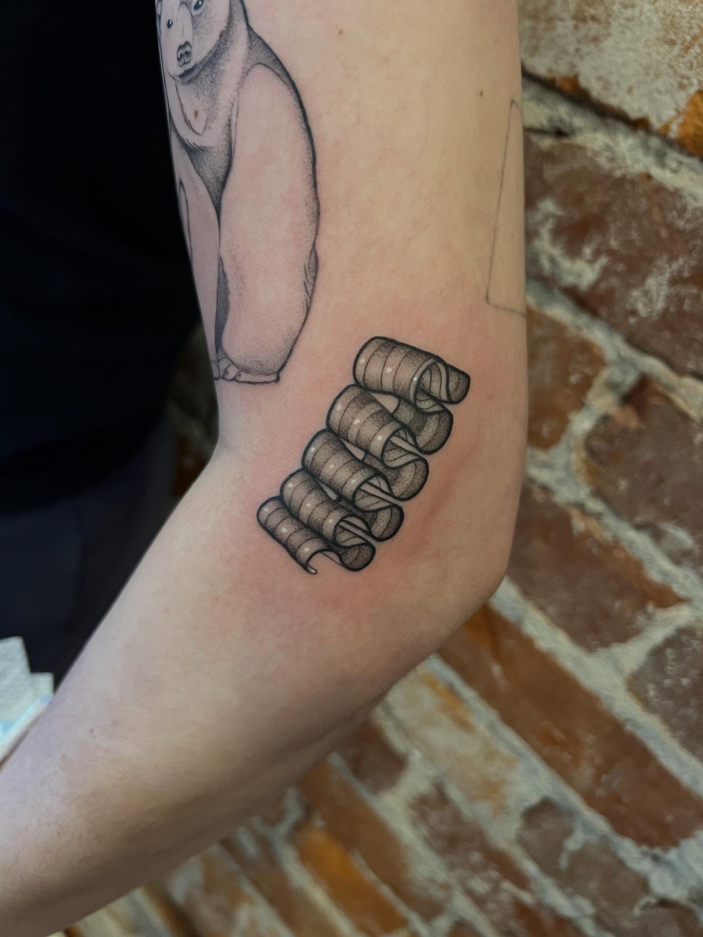 Wristband black and grey tattoo on the forearm by High Vibrations