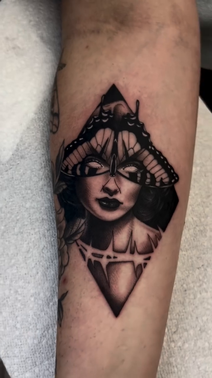 Woman with butterfly headdress realism tattoo by Sacramento Tattoos (Ilona)