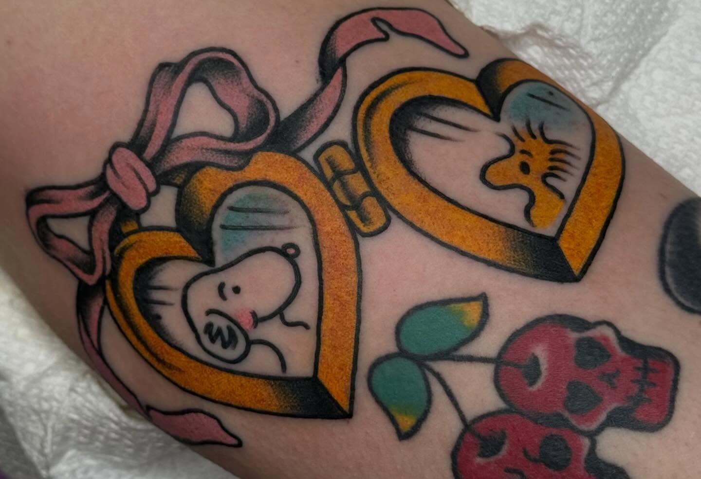 Heart with piglet American traditional tattoo on the forearm by Painted Peach Tattooer
