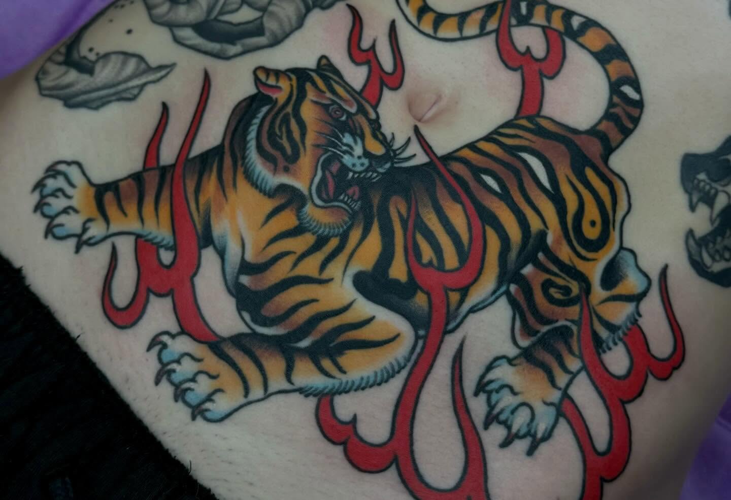 Tiger American traditional tattoo on the torso by Painted Peach Tattooer